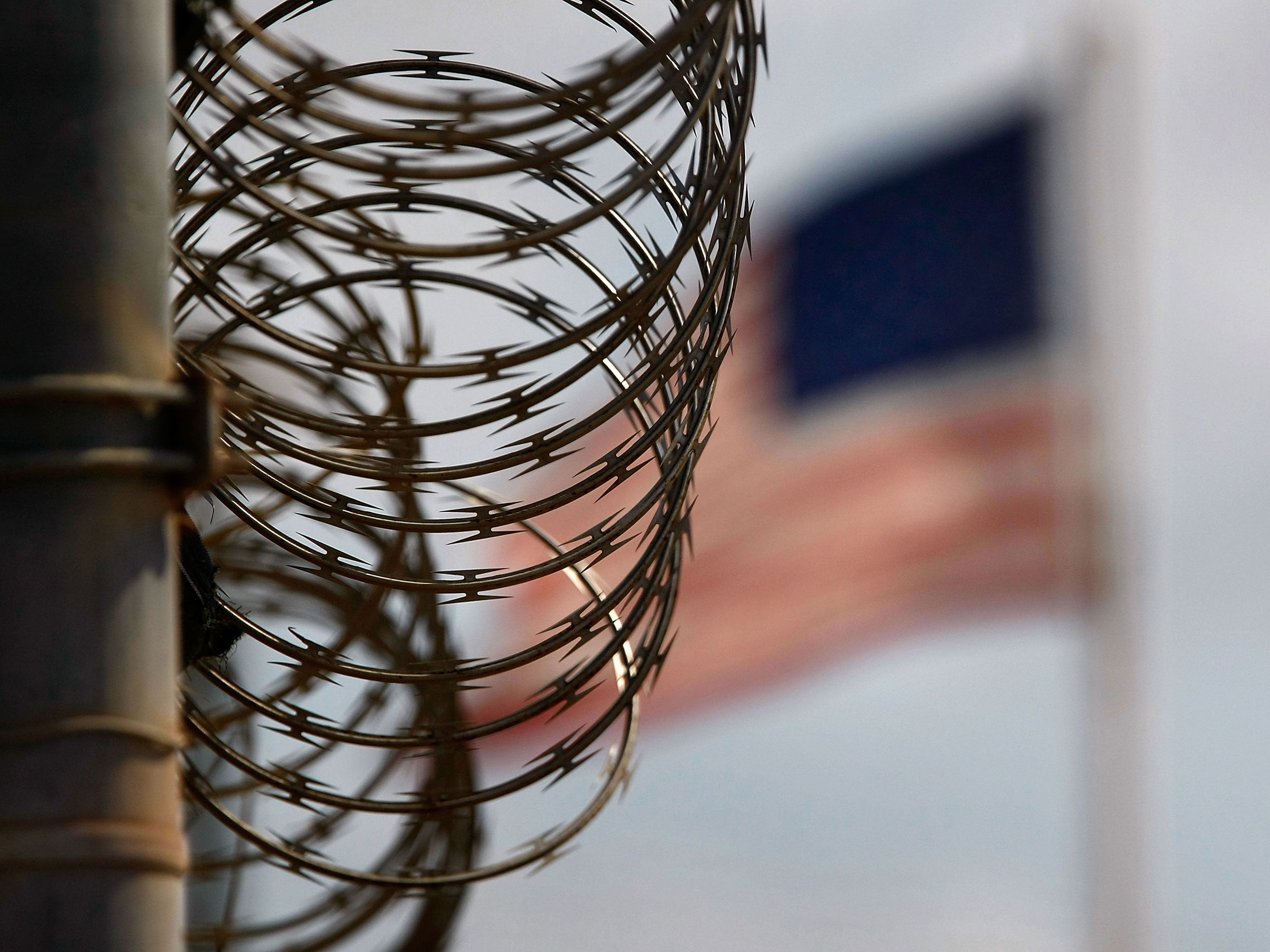 A roll of protective wire runs atop a fence in the maximum security Camp 5 at the Guantanamo Bay detention center