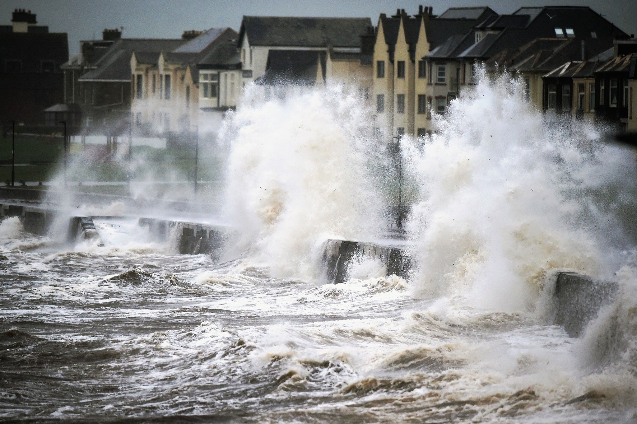 Waves crash over the promenade at Prestwick, Scotland