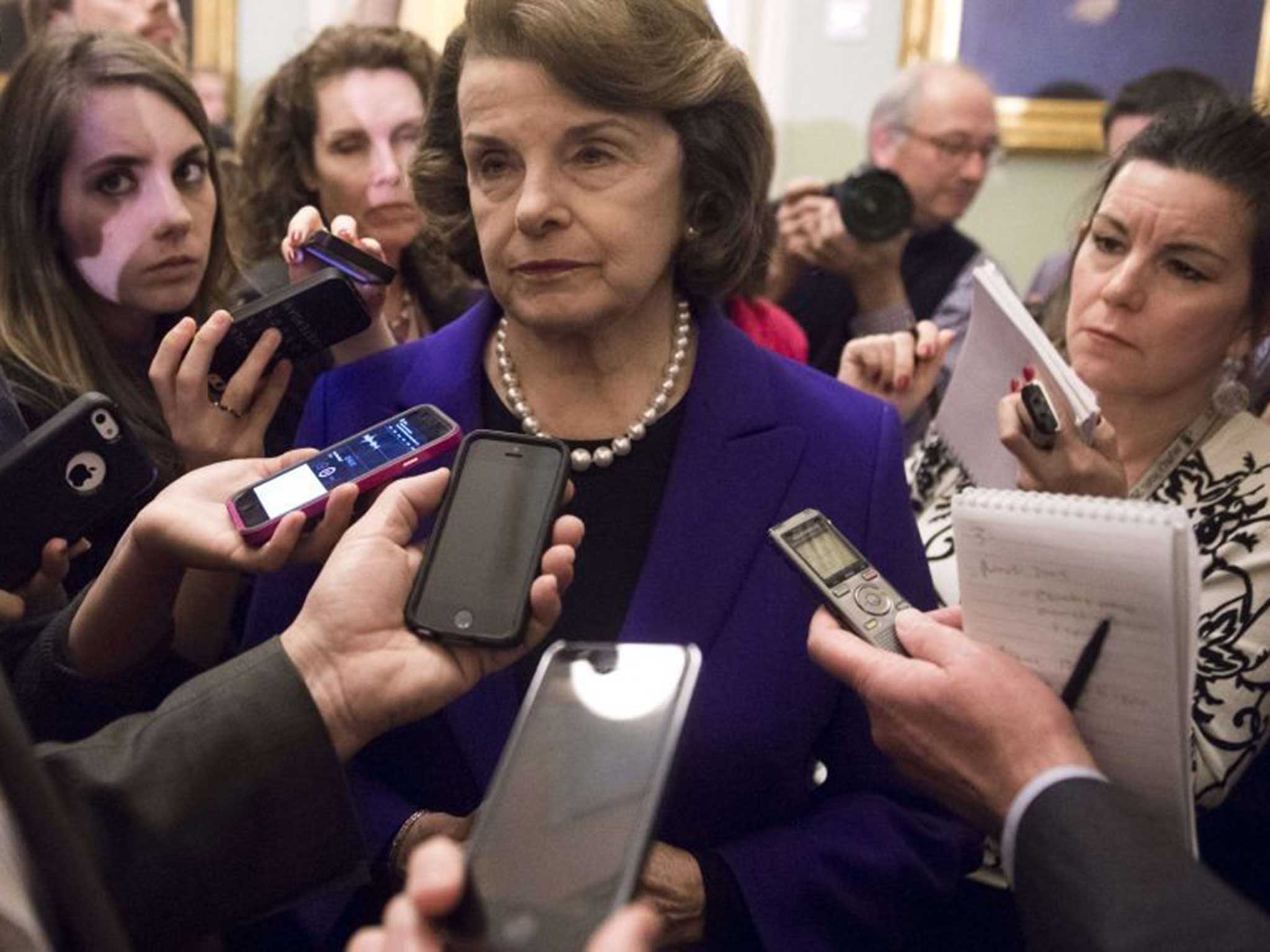 Committee chair Dianne Feinstein faces questions from the press