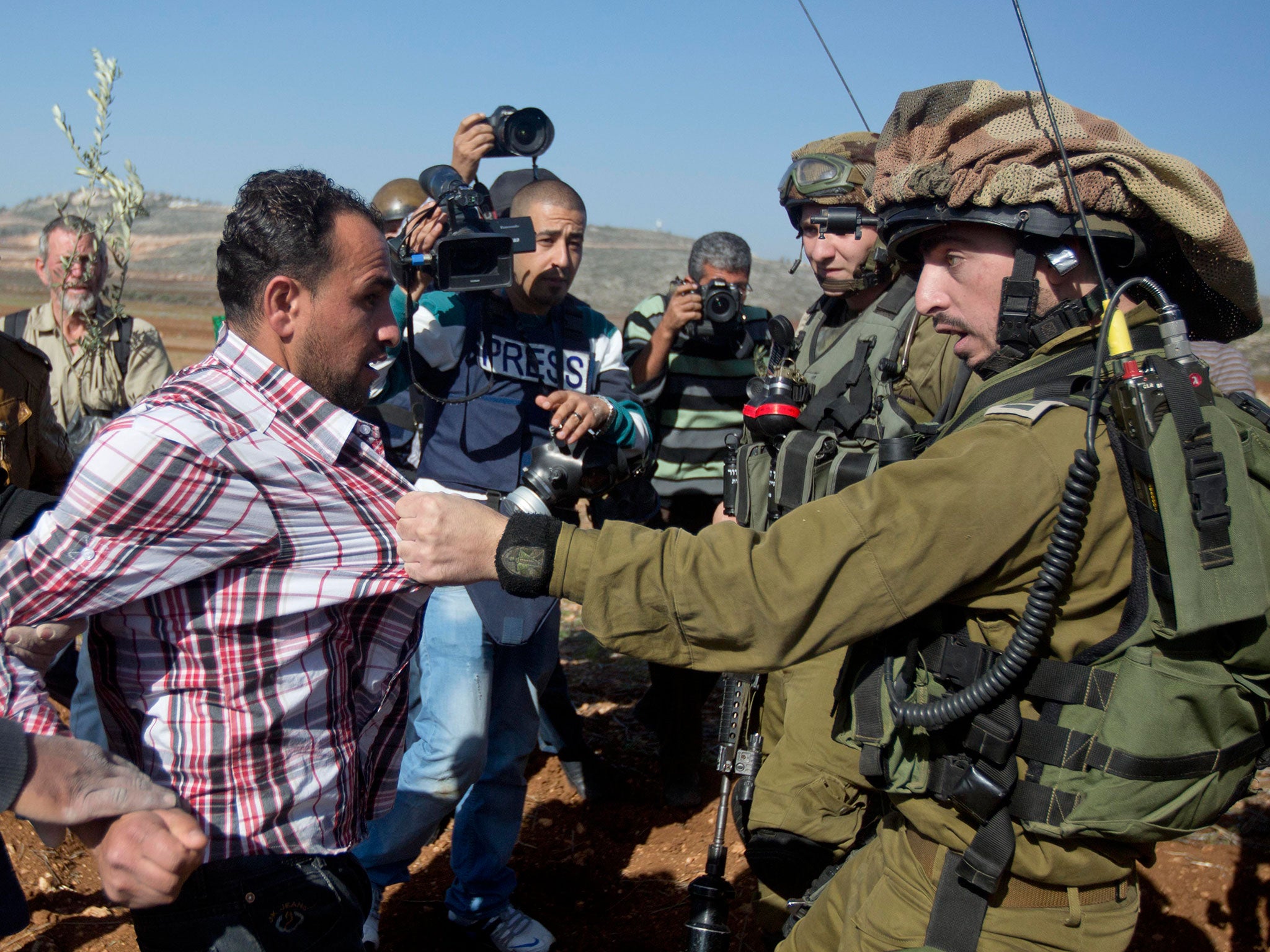 An Israeli soldier pulls a Palestinian during a demonstration against Israeli settlements in the village of Turmus Aya near the West Bank city of Ramallah