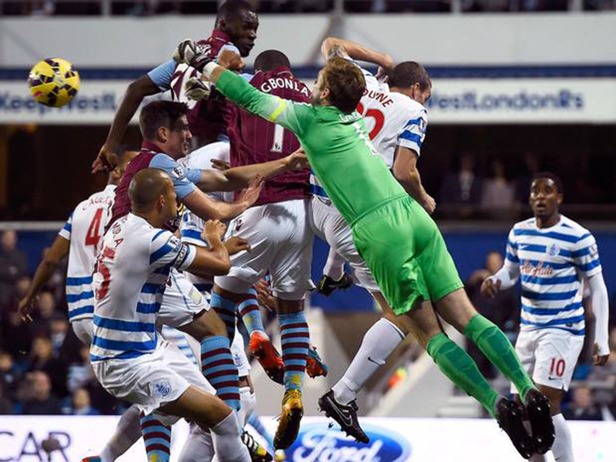 Queens Park Rangers' Robert Green (3rd R) punches the ball clear during their English Premier League soccer match against Aston Villa at Loftus Road in London