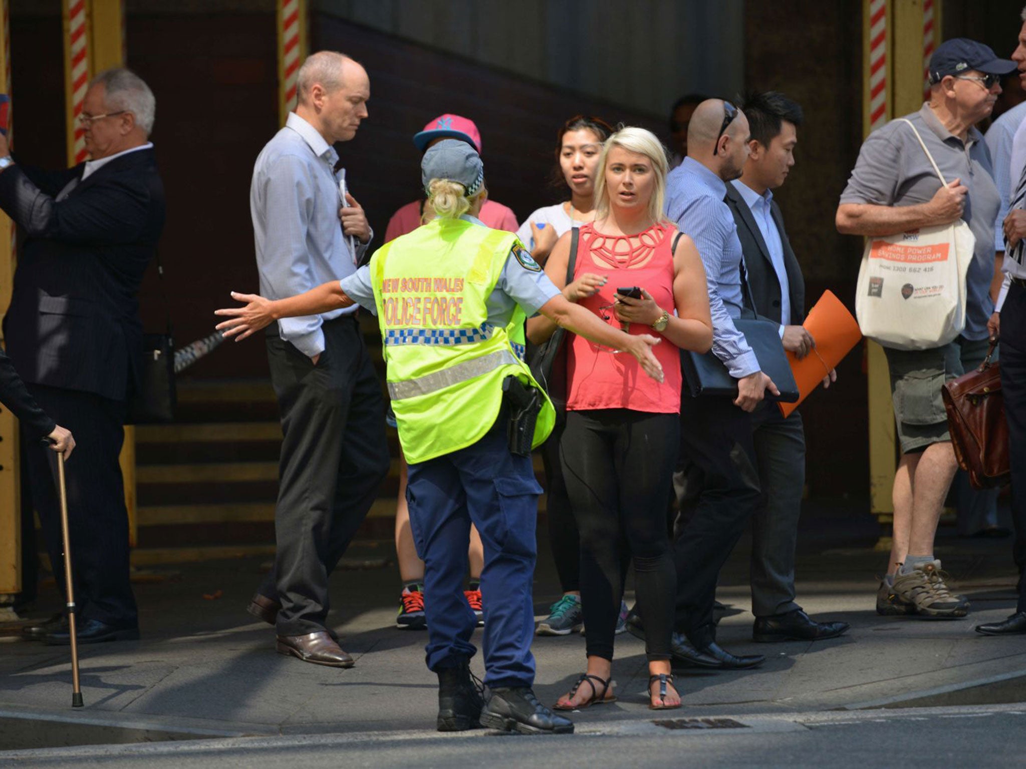 Police close a street where a cafe is being used to hold hostages in the central business district of Sydney