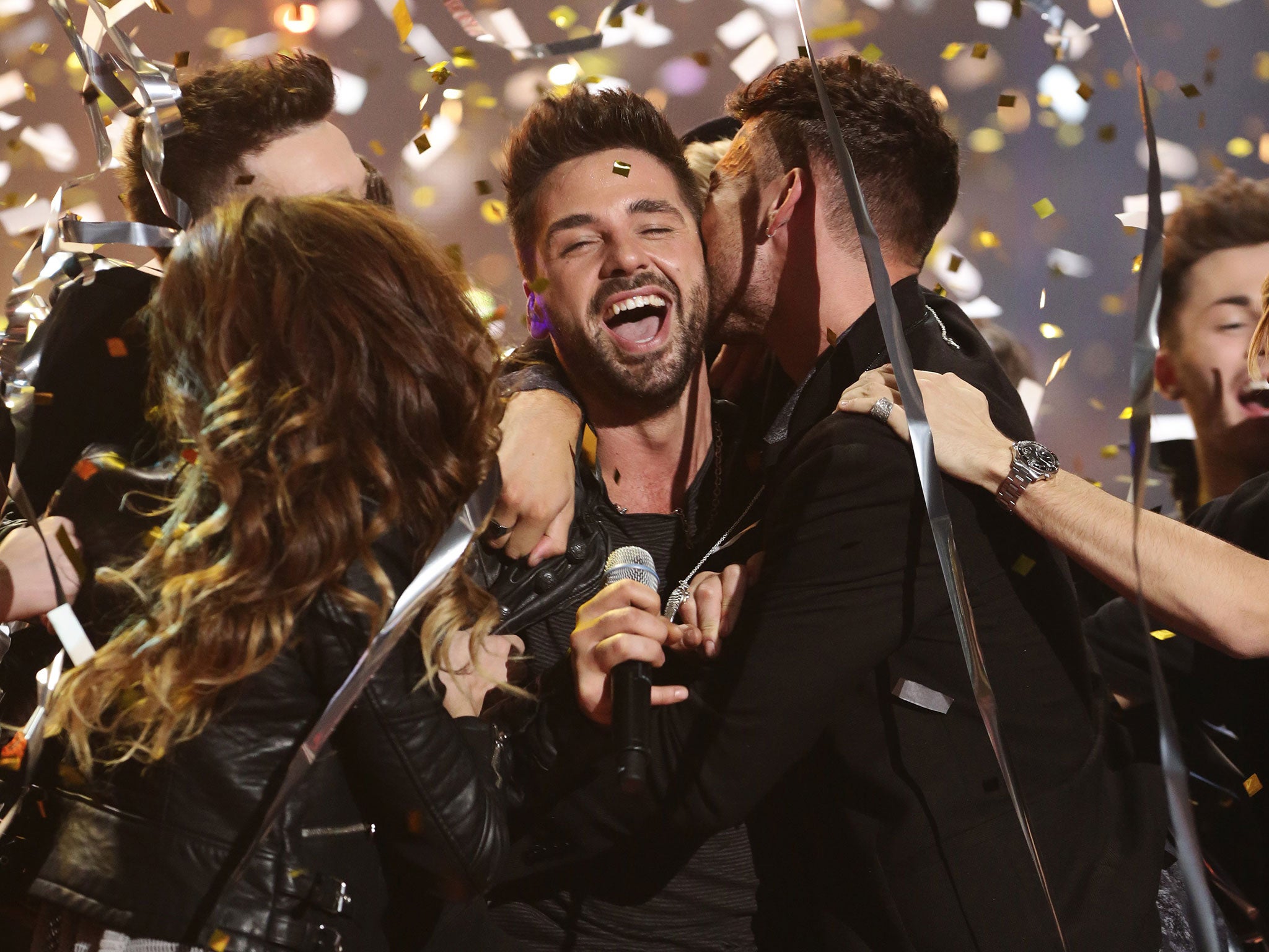 Ben Haenow is mobbed by his fellow X Factor contestants after winning the 2014 show