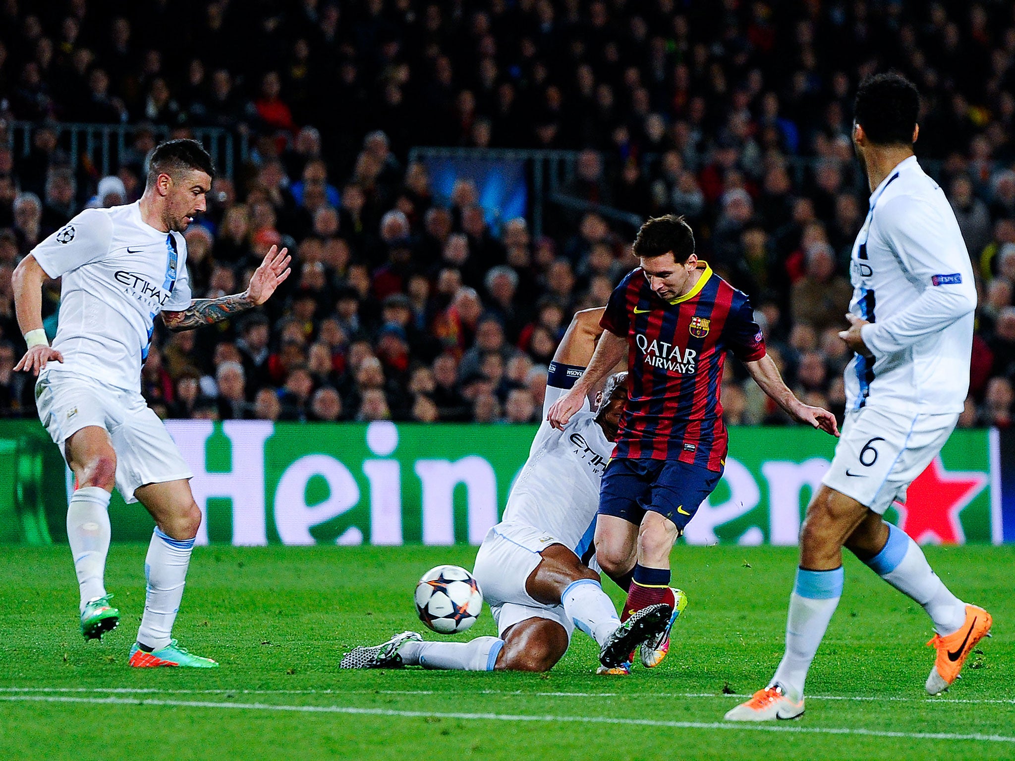 Lionel Messi and Vincent Kompany duel for the ball