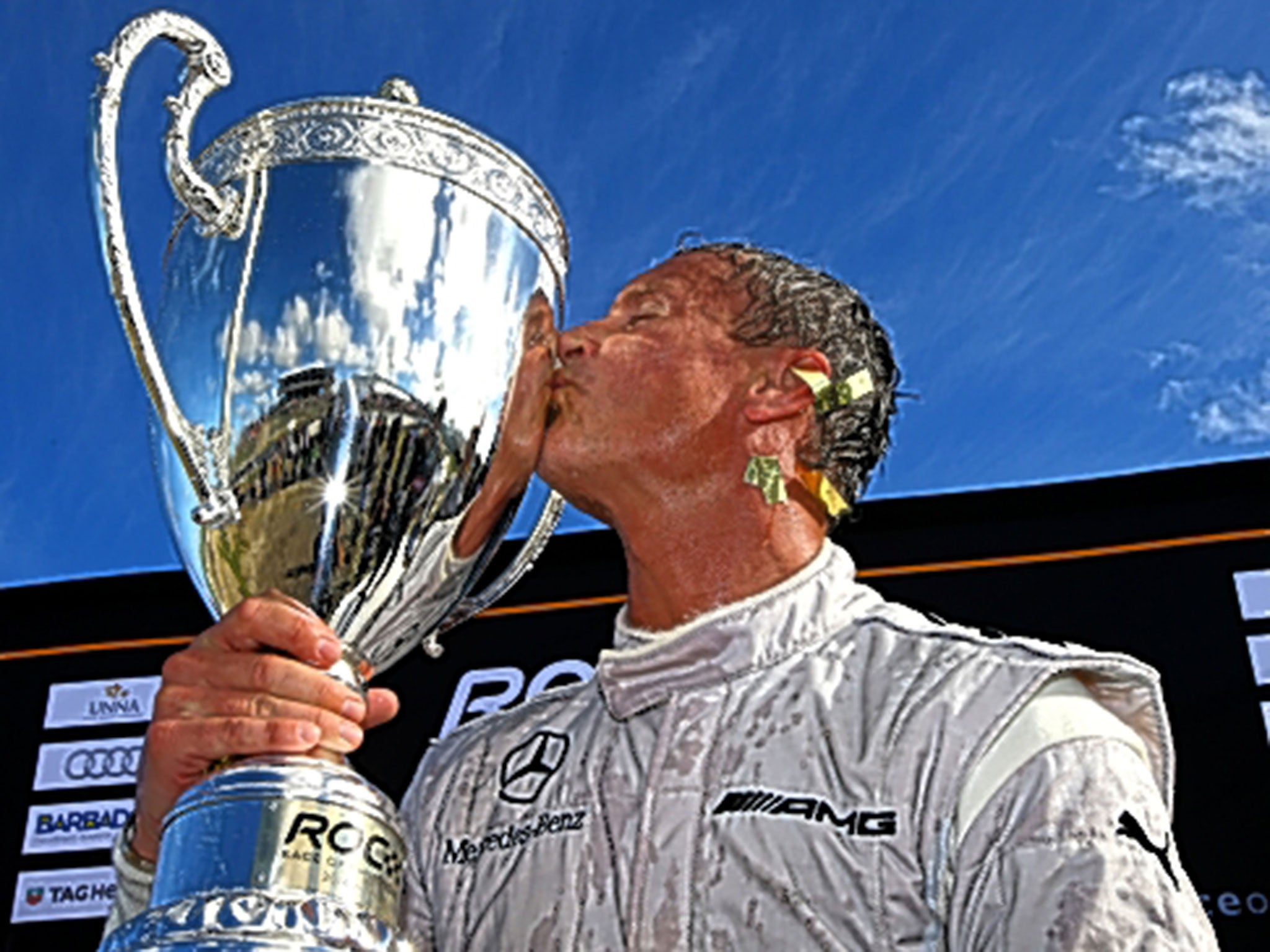 Coulthard celebrates after picking up the winners’ trophy