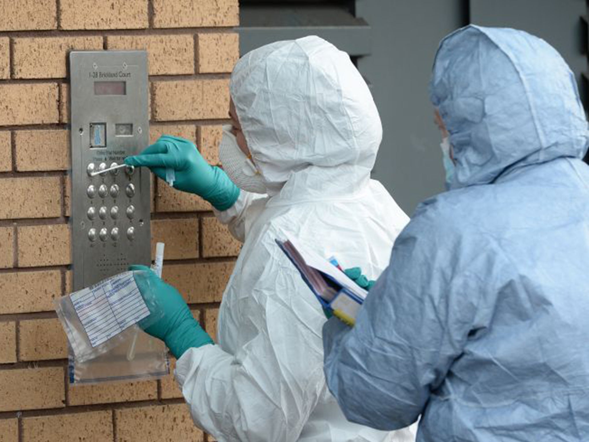 The area at the entrance of the flats was sealed off while forensic experts examined the entry system