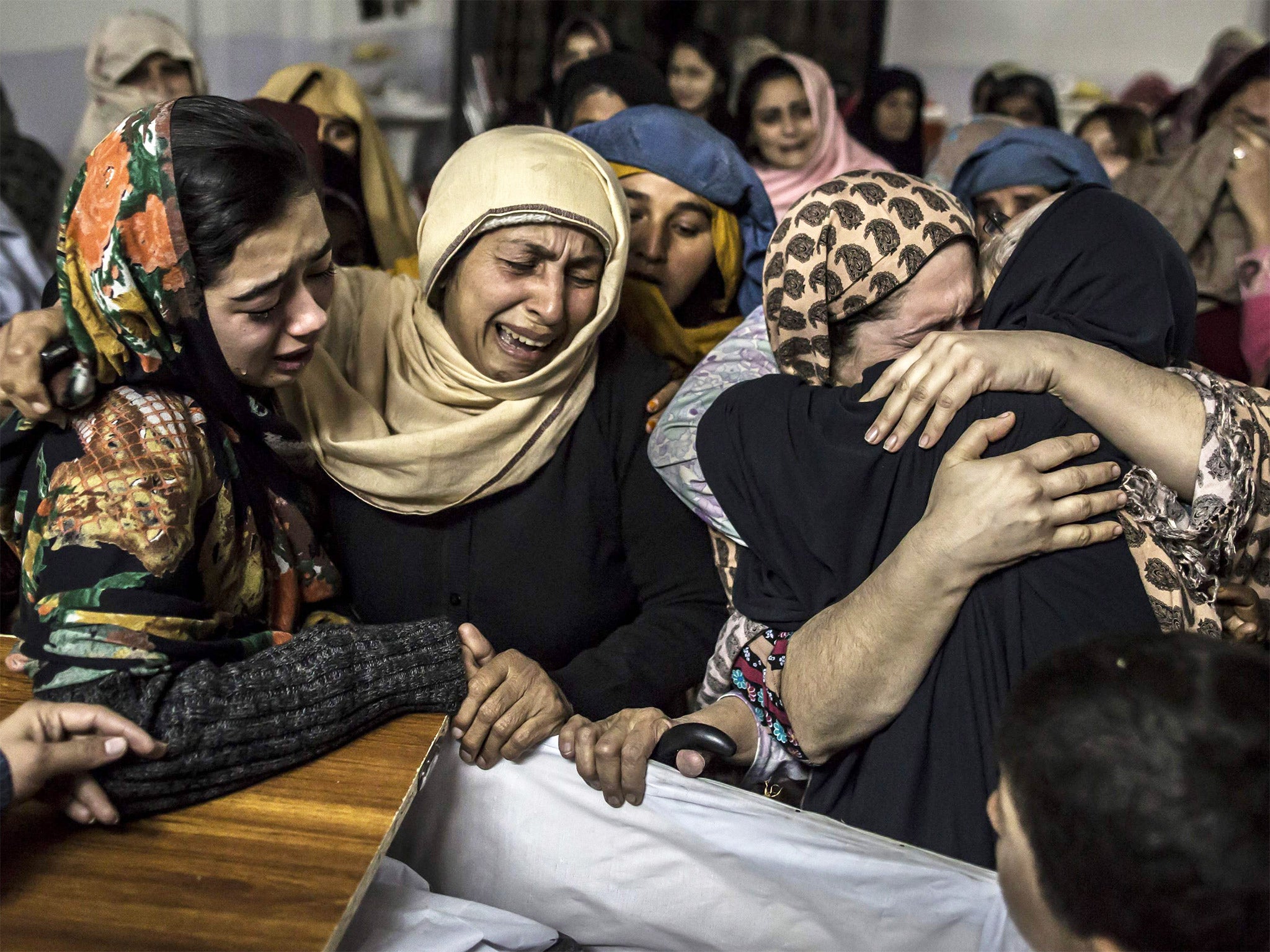 Women mourn the death of a relative who was killed during the attack on the Army Public School, in Peshawar