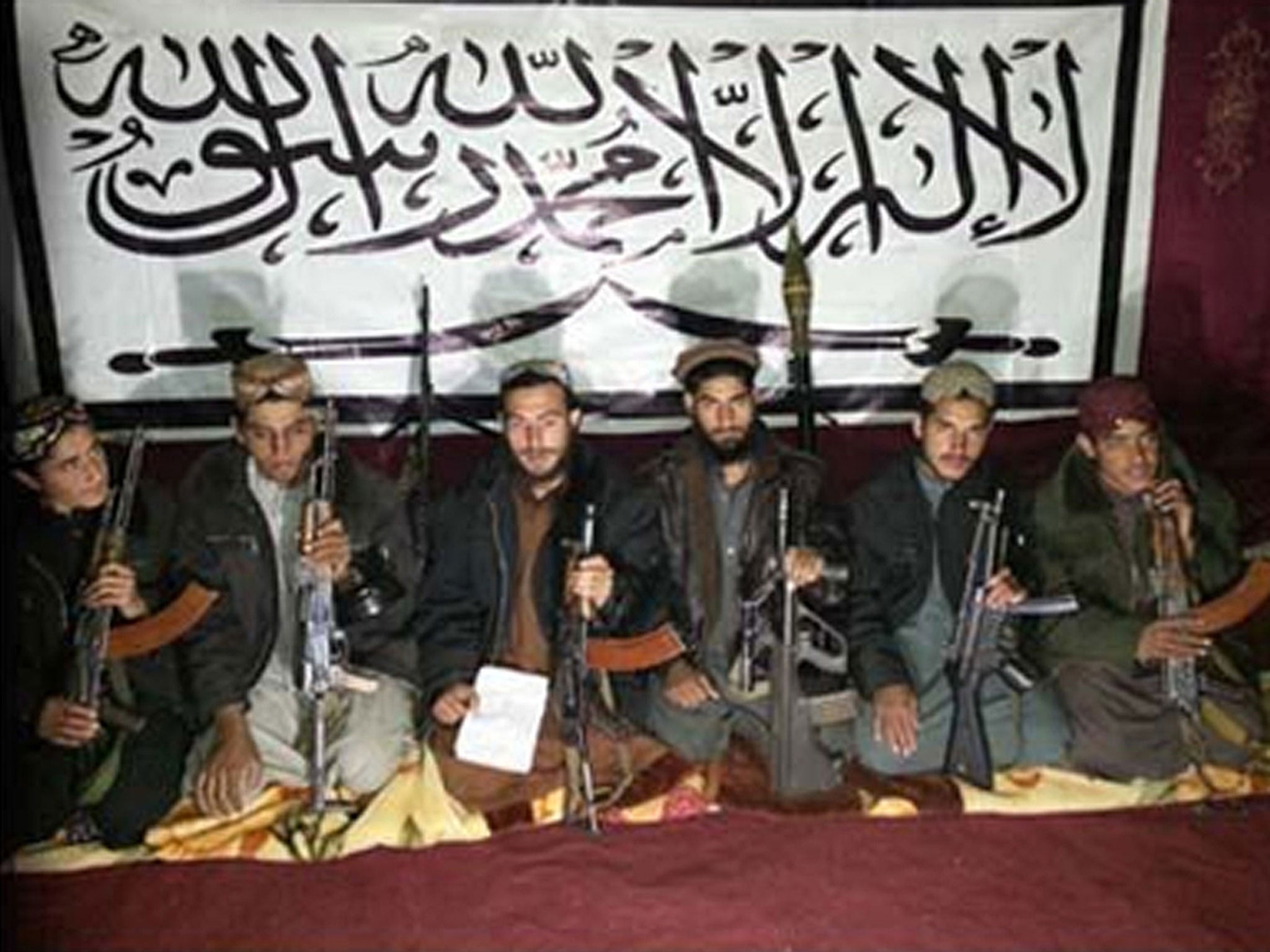 In photos released by the Taliban, between six and seven men carrying guns can be seen pictured in front of a white banner