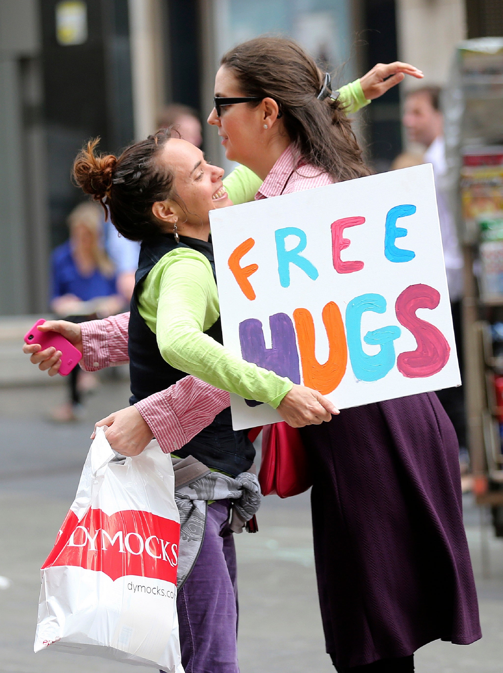 Michelle Cotterill giving a woman a hug in the area of the Lindt café