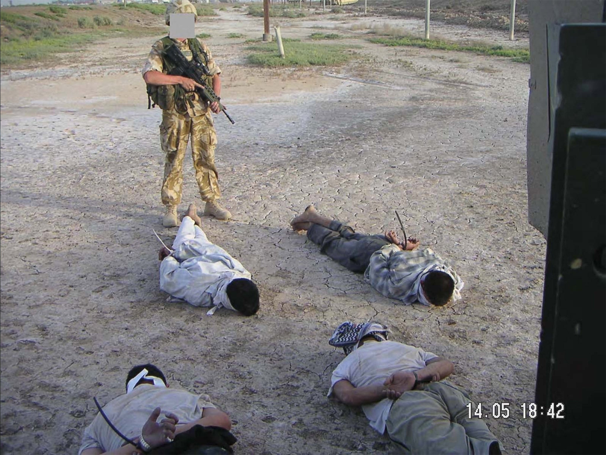 This image of detained Iraqis being guarded by a British soldier was shown at the The Al-Sweady Inquiry