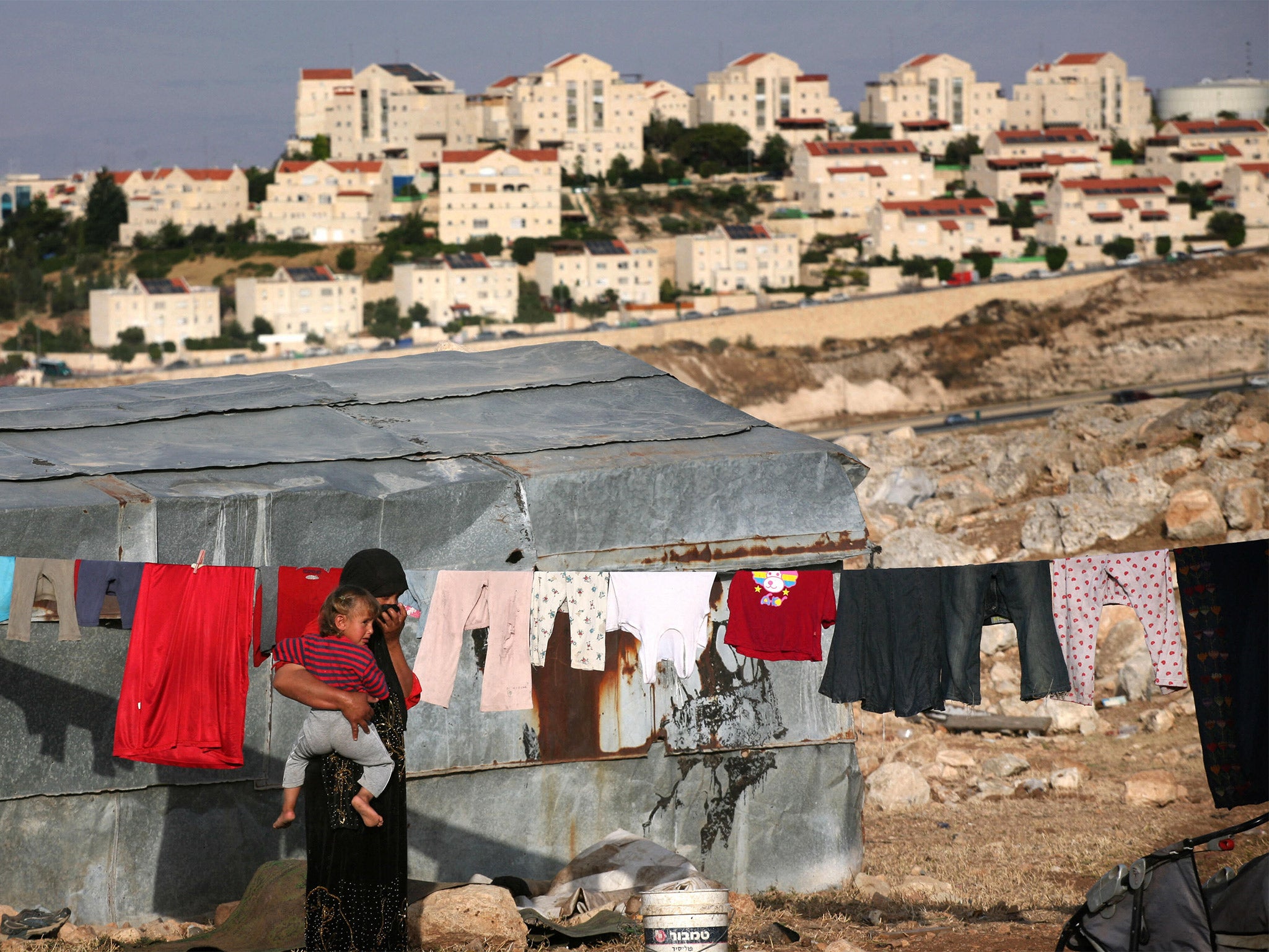 Bedouin people overlook Israeli settlements in the West Bank, which have multiplied over 40 years