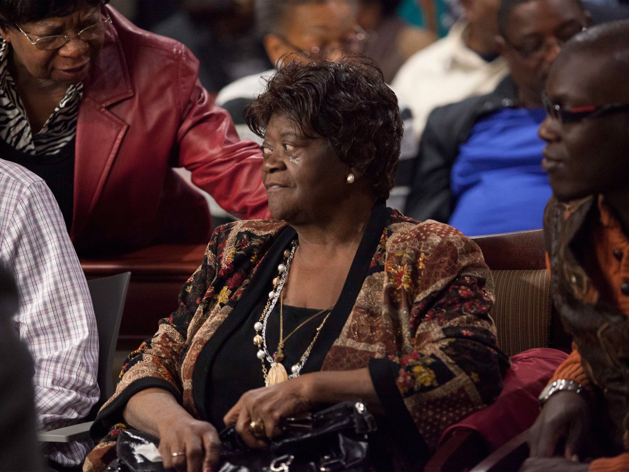 Aime Ruffner receives support from family and friends after testifying at the hearing to reopen the case for her brother