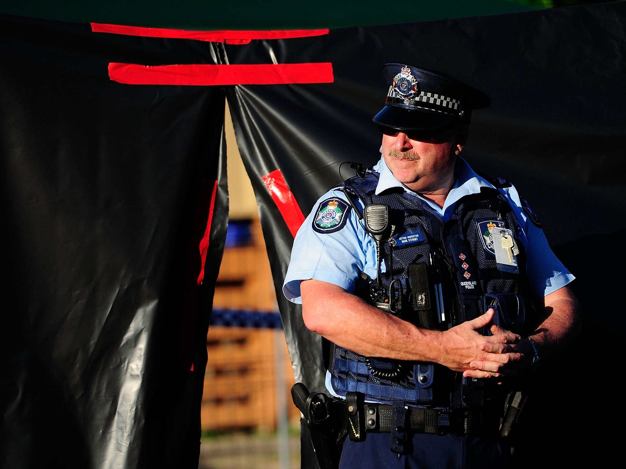 Police attend the scene of a multiple stabbing in the suburb of Manoora in Cairns