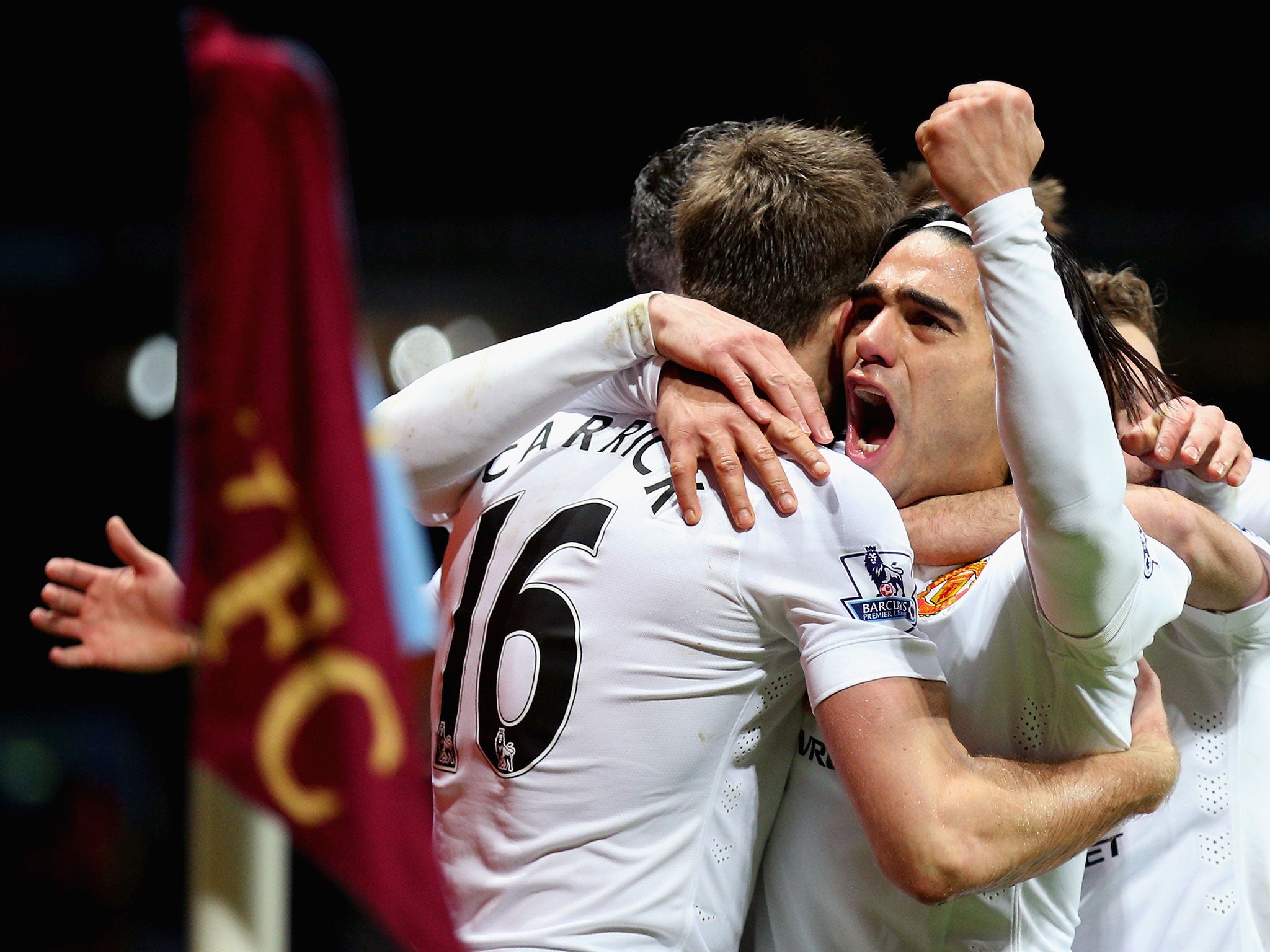 Manchester United players embrace striker Radamel Falcao after his goal