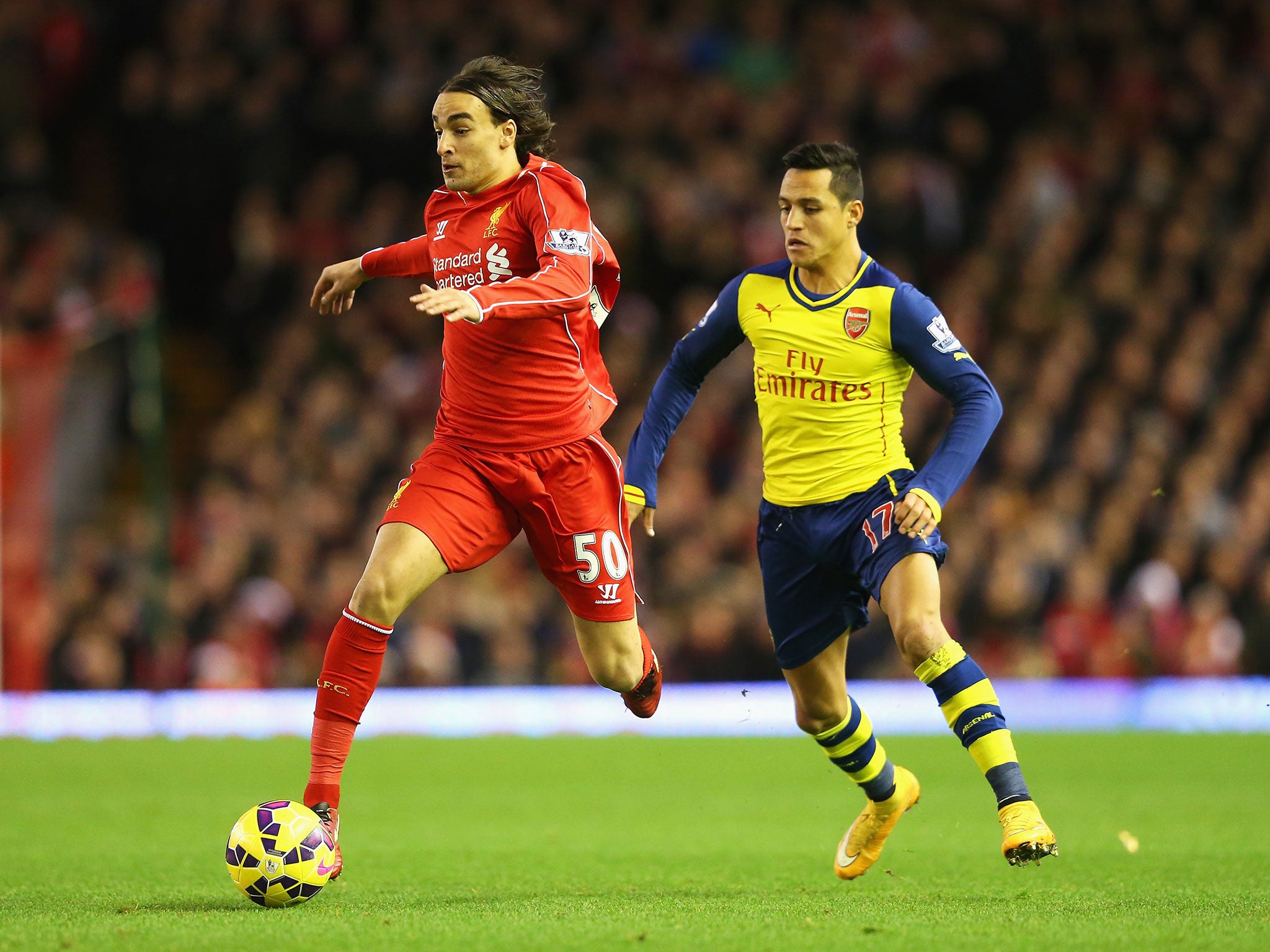 Lazar Markovic runs past Alexis Sanchez