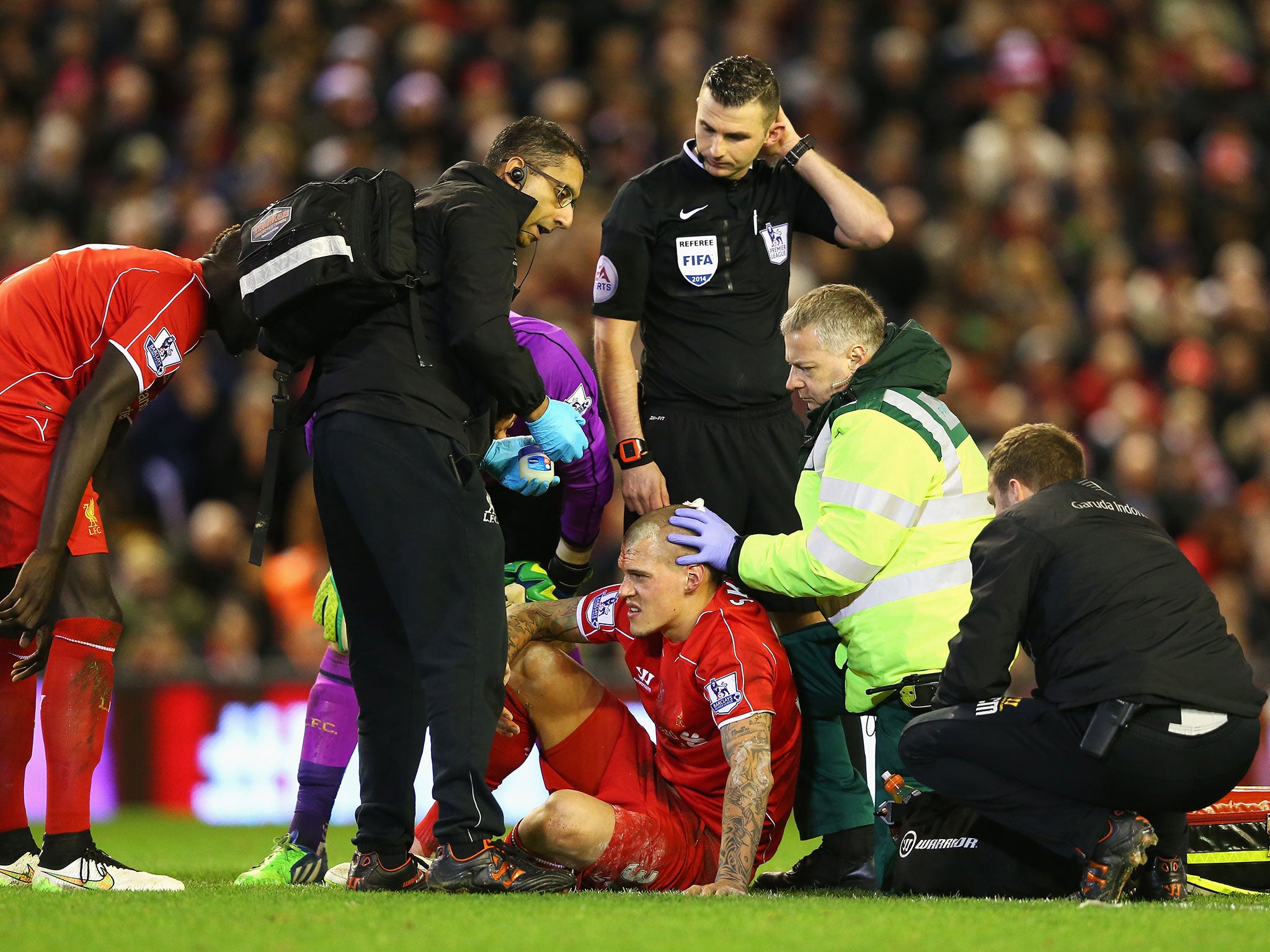 Martin Skrtel is treated after Olivier Giroud clash