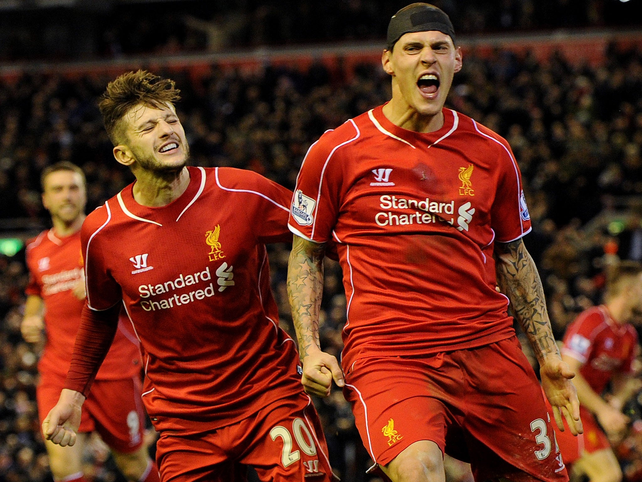 Skrtel (right) wheels away in celebration