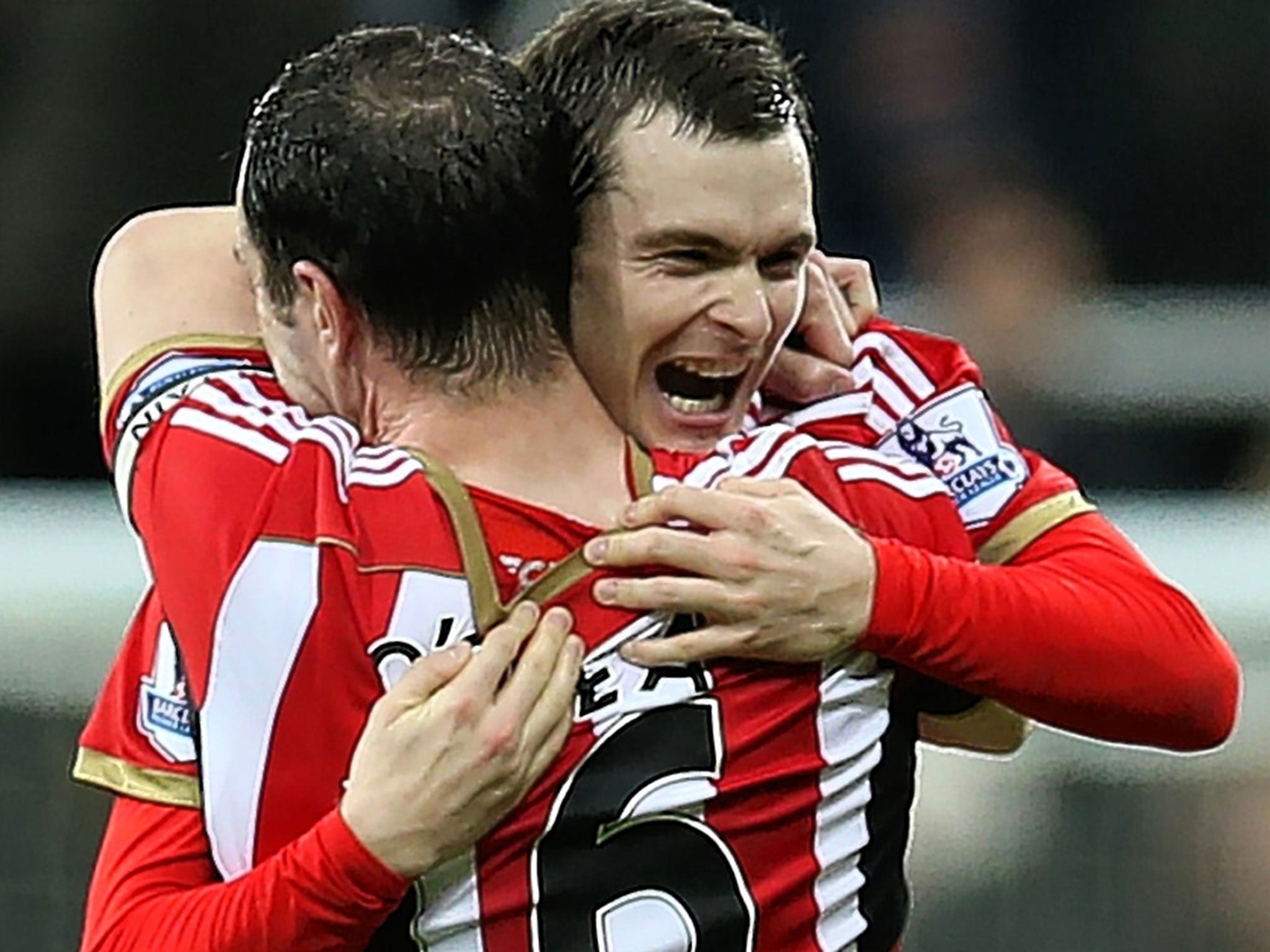 Adam Johnson (right) gets a celebratory hug from John O’Shea on Sunday