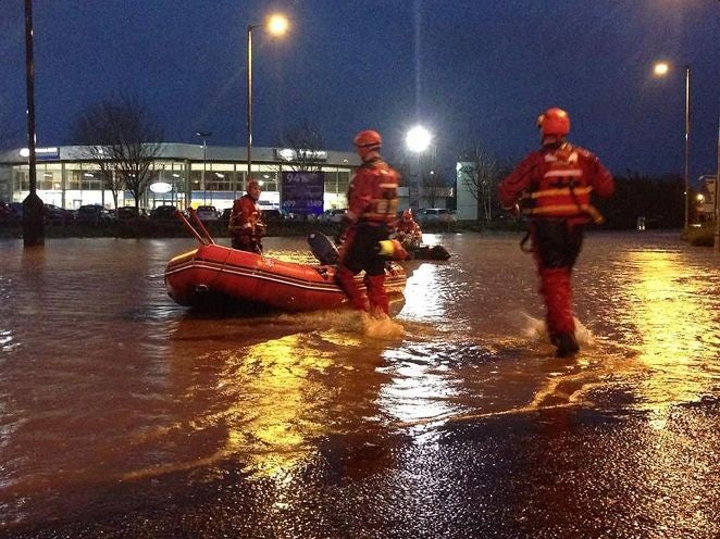 Emergency services helping stranded people at an Asda supermarket in Kilmarnock, after the River Irvine burst its banks