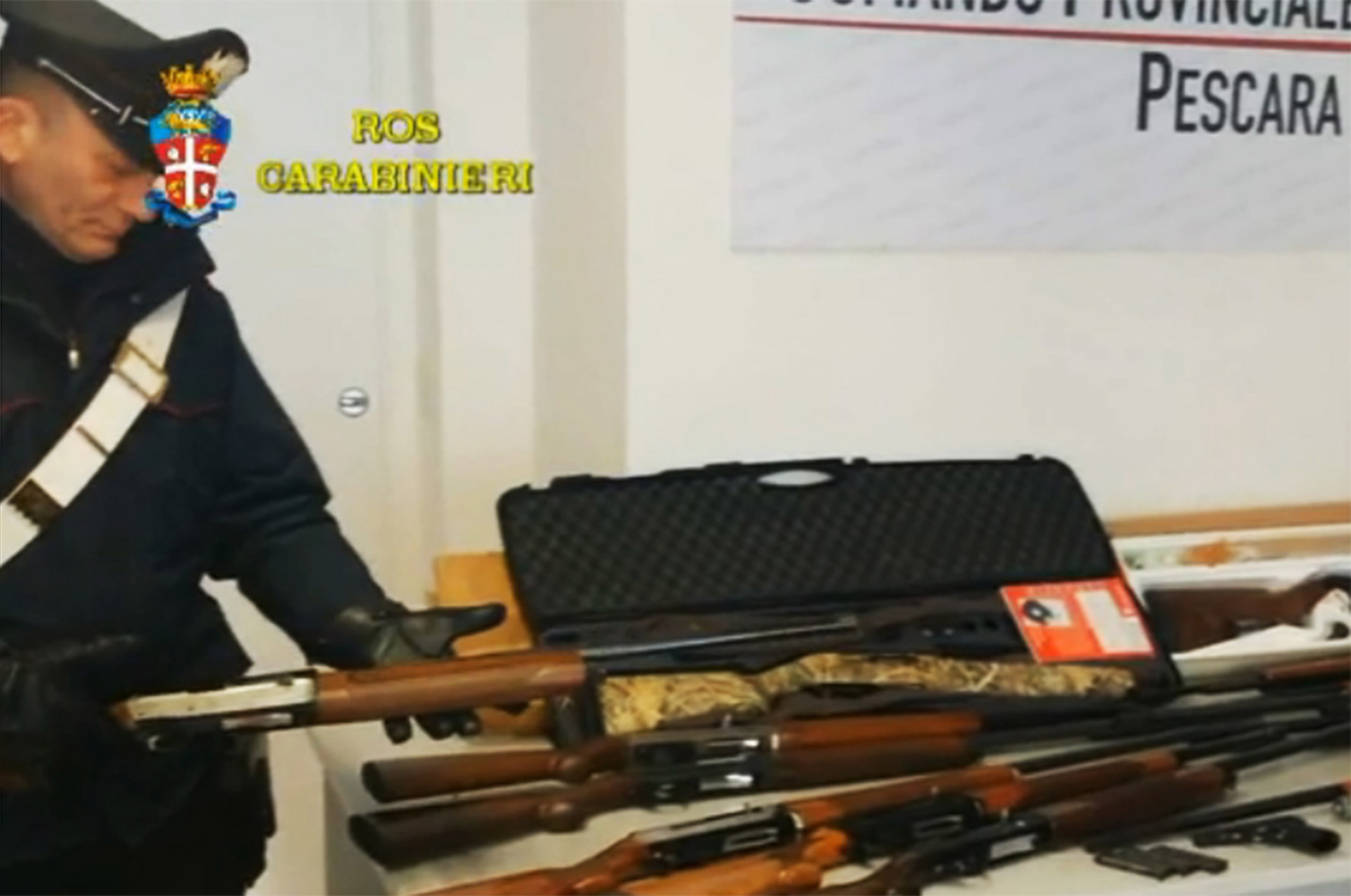 A Carabiniere policeman shows sized weaponry in Pescara, Italy