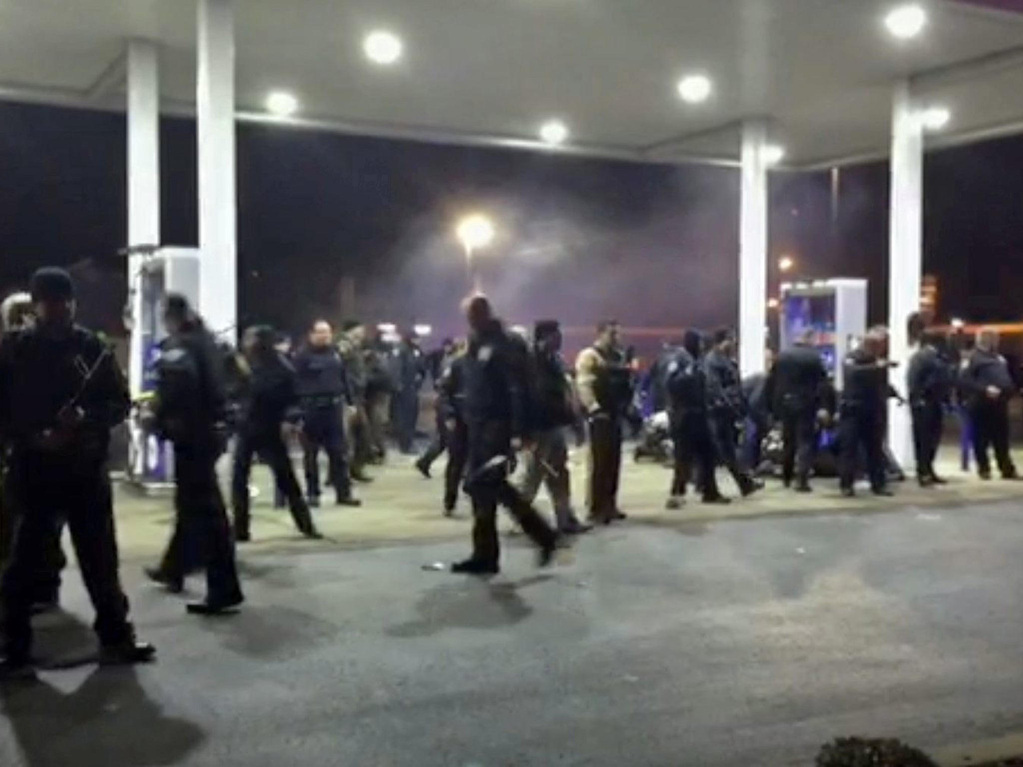 Police officers forming a line as they cordon off the site