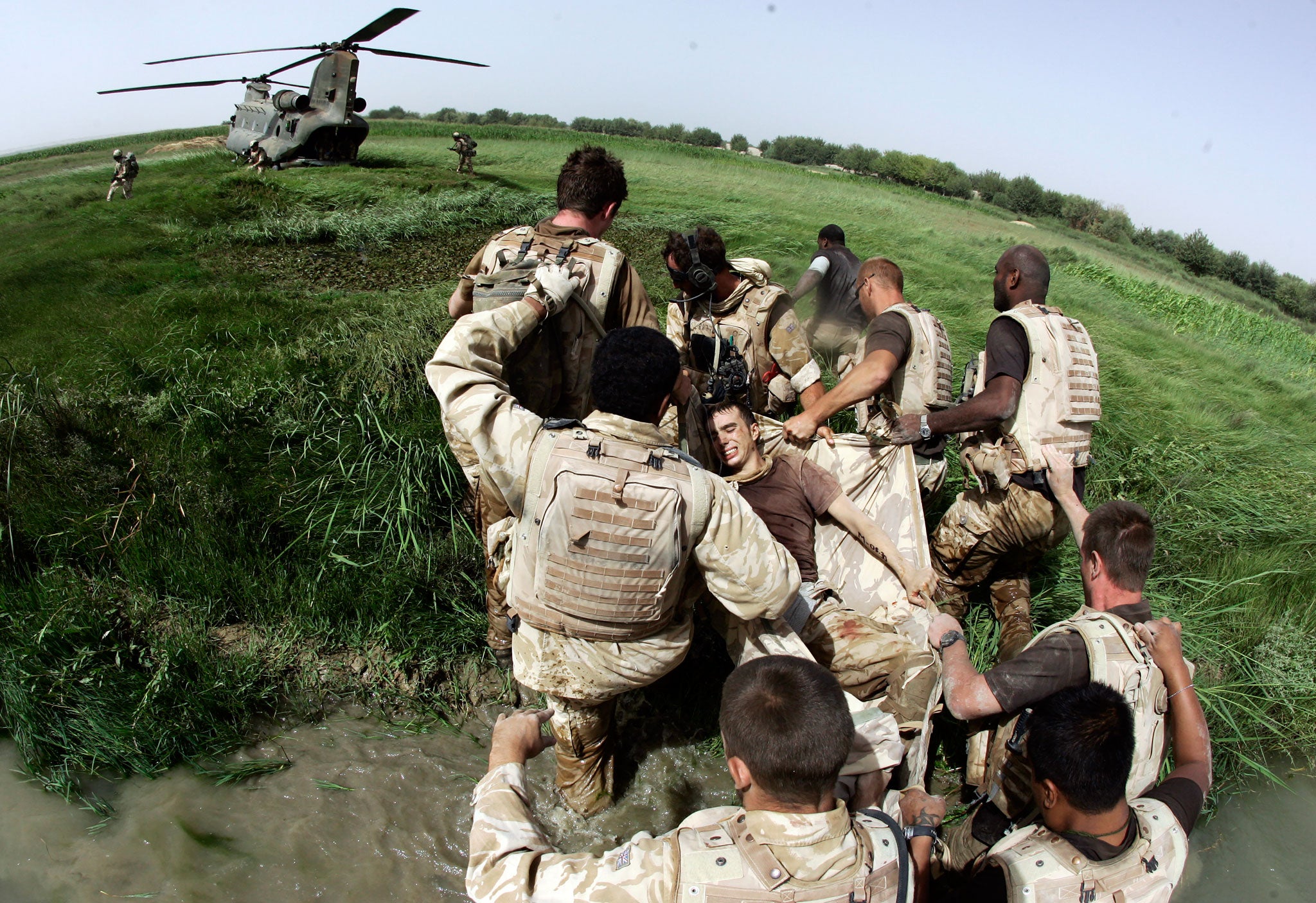 Lance Corporal Clint Buchanan, top left, helps bear the stretcher taking Private Davey Graham to a waiting Chinook
