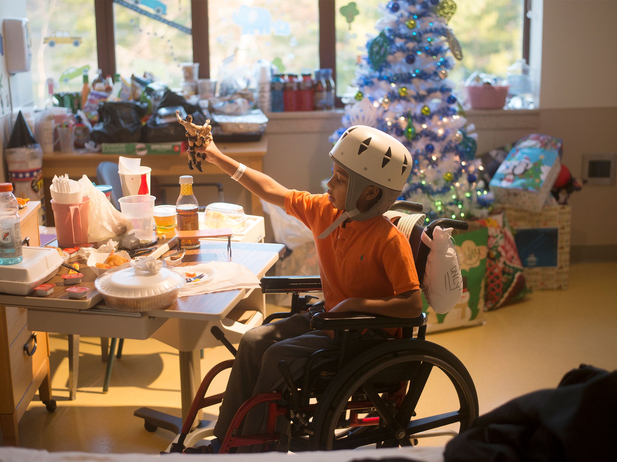 Jaydan Stancil, 9, plays with wrestling figures after one of his physical therapy sessions