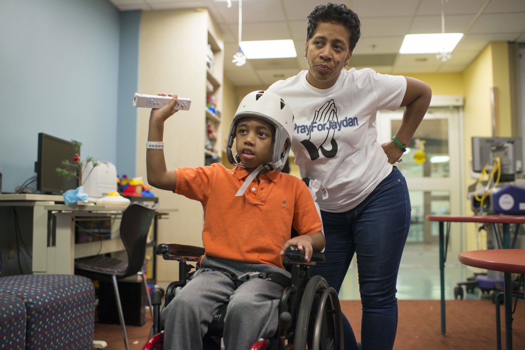 Monique Nichols tells her son Jaydan Stancil, 9, to stop playing video games and get ready for bed