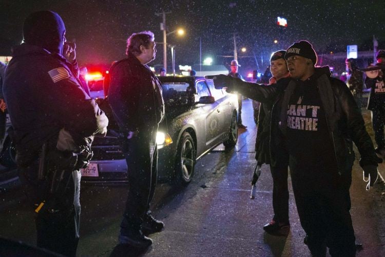 A protester confronts a police officer in Berkeley