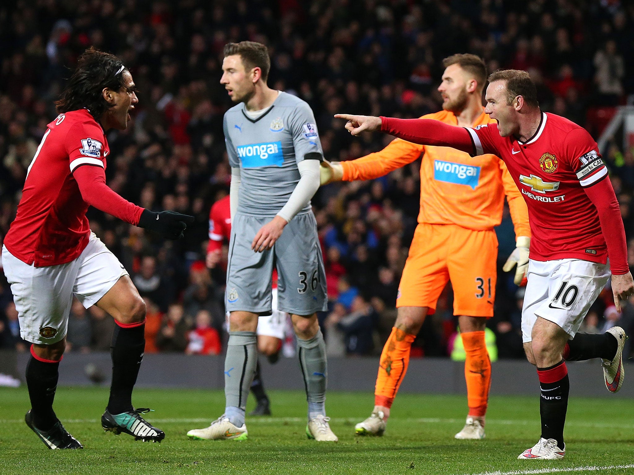 Rooney celebrates with striker-partner Radamel Falcao after the pair combine to put United ahead