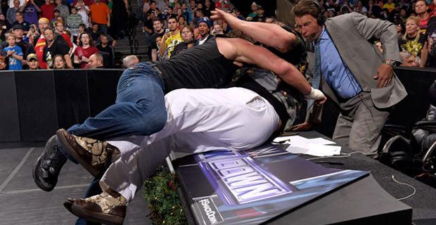 Dean Ambrose and Bray Wyatt brawl on the announcers' table