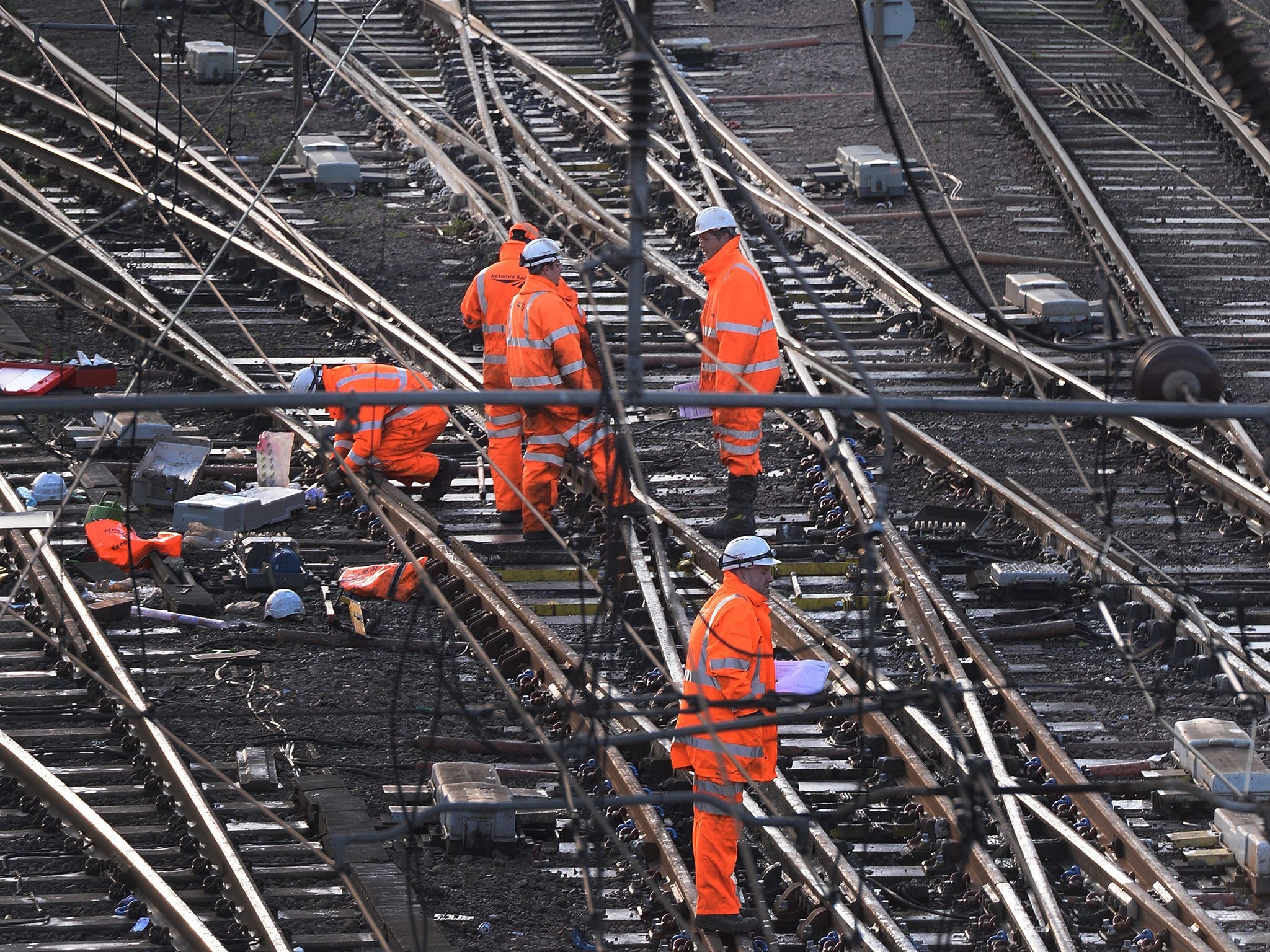 Railway workers on the tracks outside King's Cross, London, as trains in and out of the station have been cancelled because of overrunning Network Rail engineering works