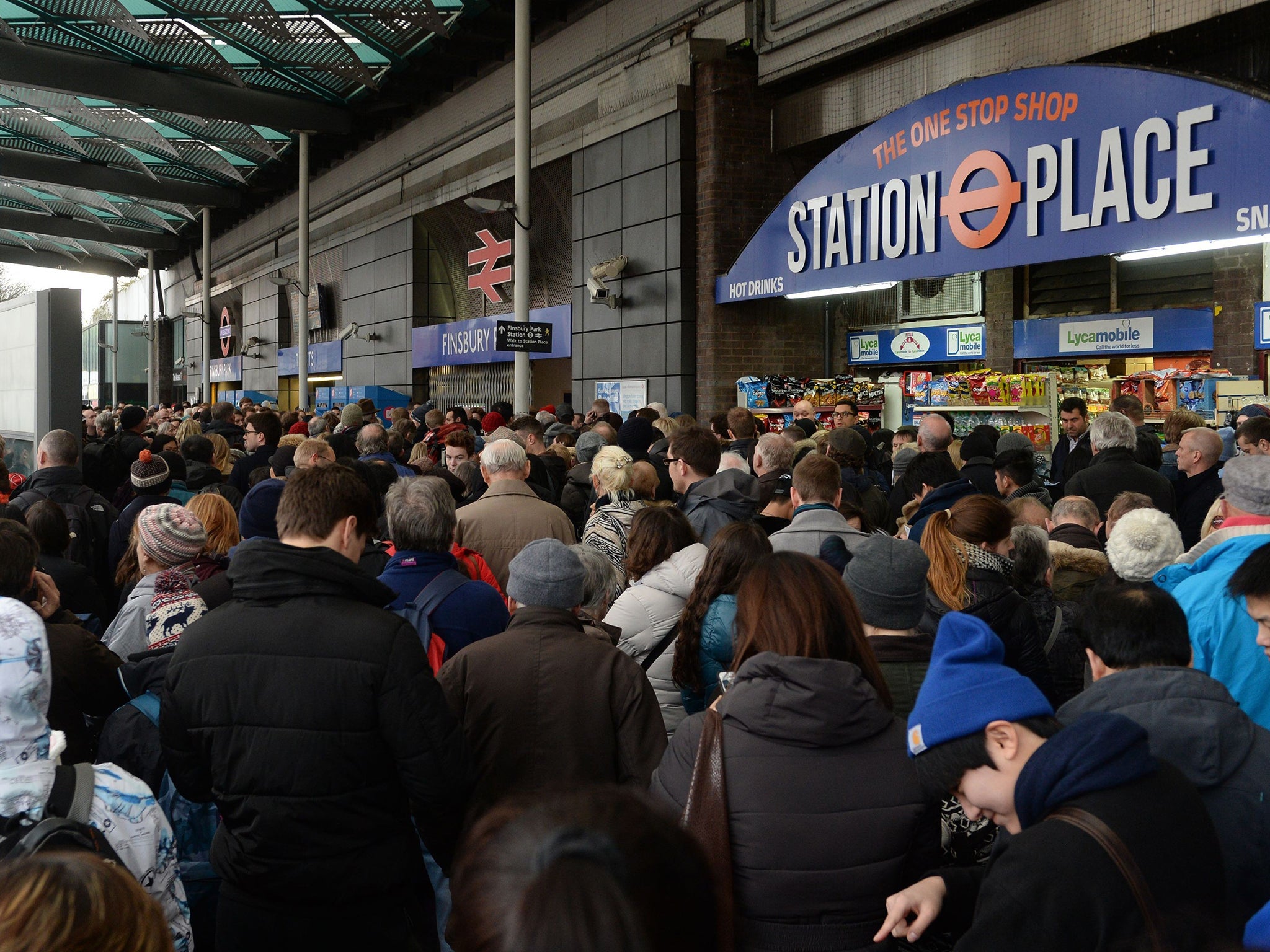 Travelers are locked out of Finsbury Park station, London, where they were directed to go as trains in and out of King's Cross have been cancelled