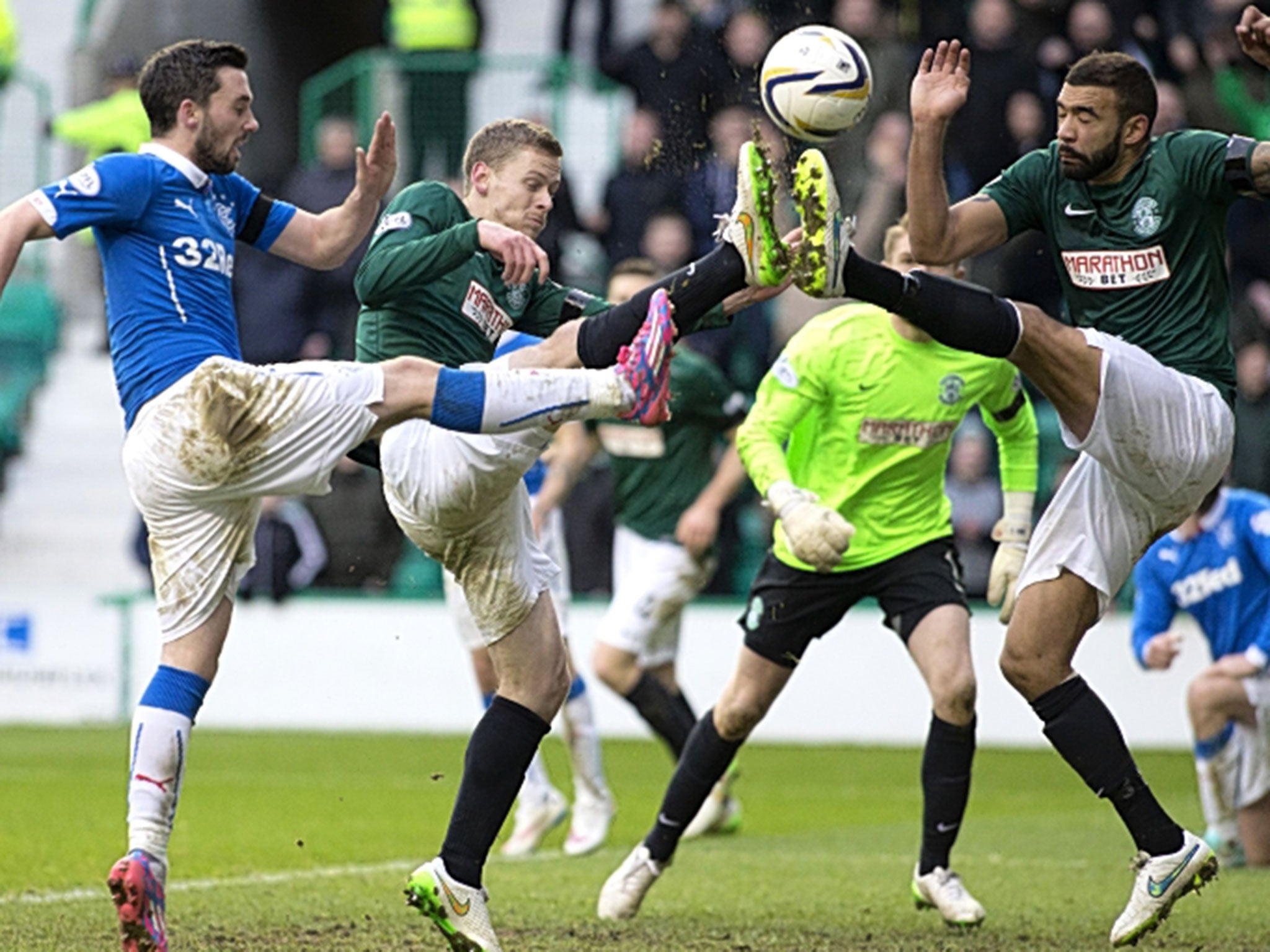 Up in the air: Rangers’ Nicky Clark (left) challenges Hibs’ Liam Fontaine