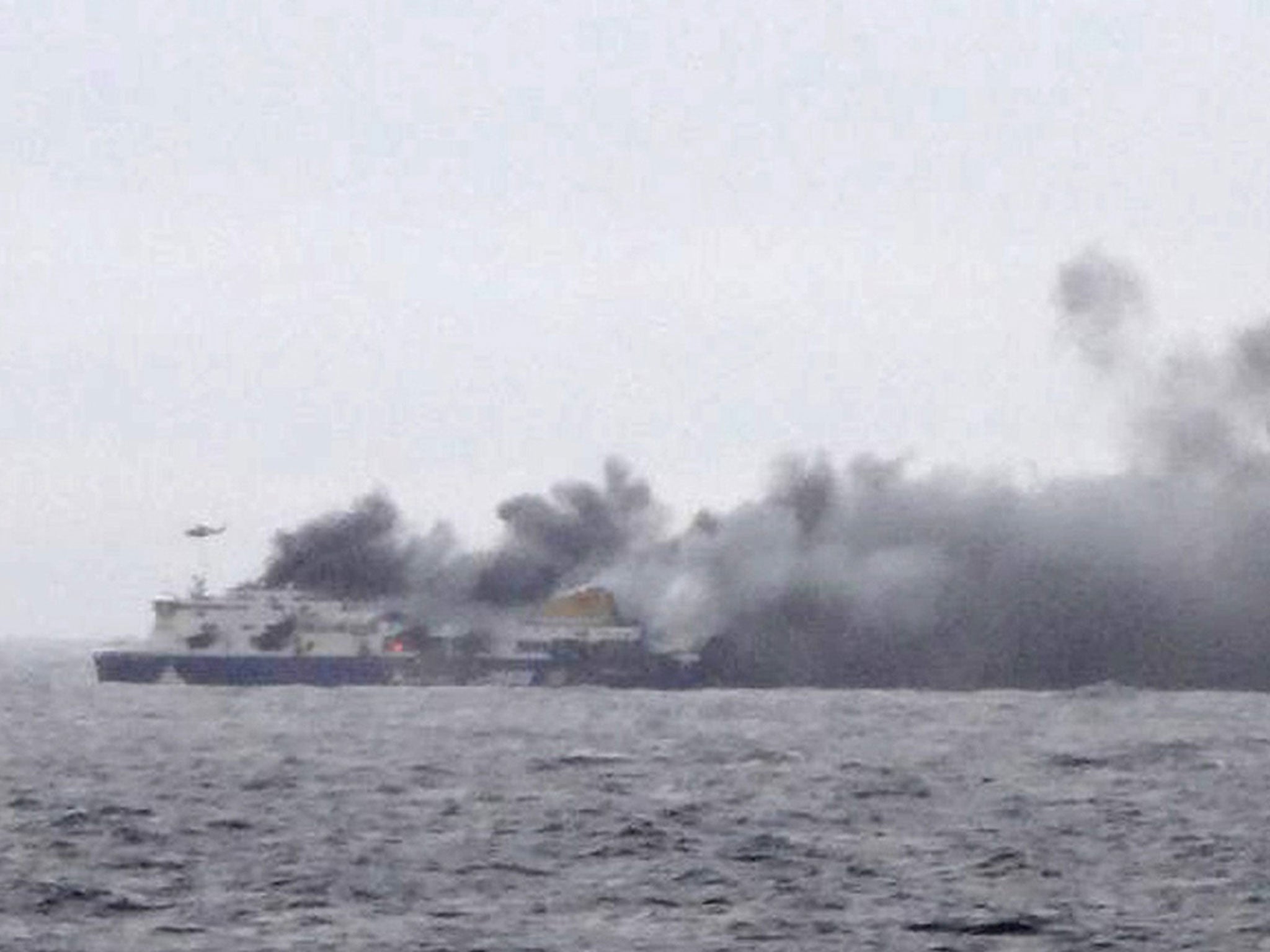 In this photo taken from a nearby ship, smoke rises from the Italian-flagged Norman Atlantic after it caught fire in the Adriatic Sea