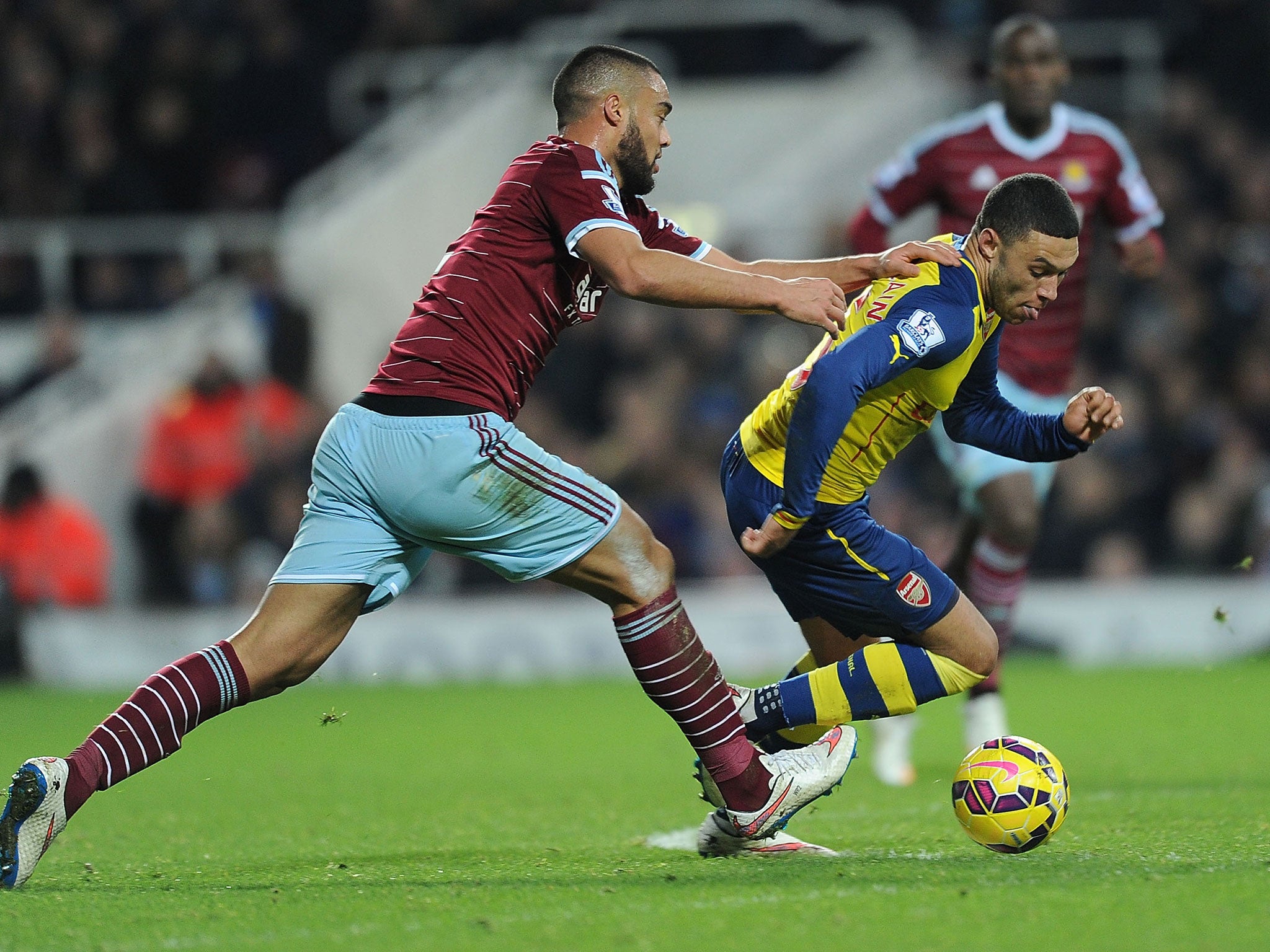 Alex Oxlade-Chamberlain (right) evades the challenge of Winston Reid on Sunday