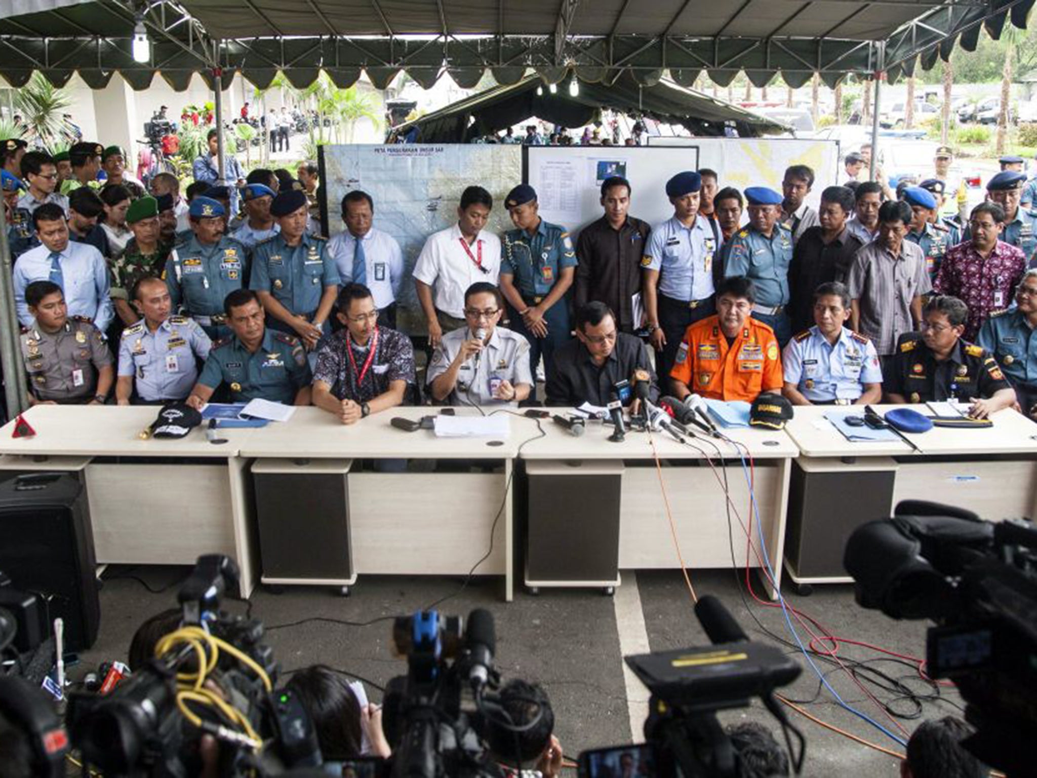 Indonesian representatives of the various search and rescue organisations and Air Asia give a press conference on the hunt for the missing plane