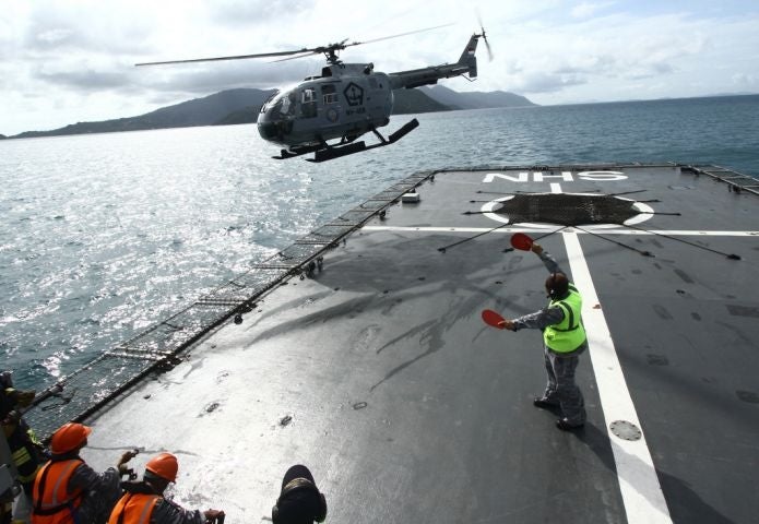 An Indonesian Navy helicopter assists in the search for missing AirAsia flight QZ8501 near Batam, south of Singapore