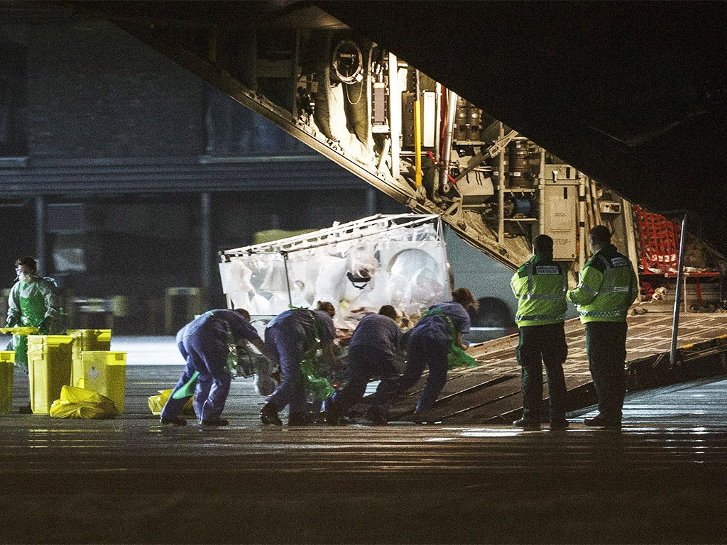 Pauline Cafferkey is wheeled in a quarantine tent trolley onto a plane at Glasgow International Airport