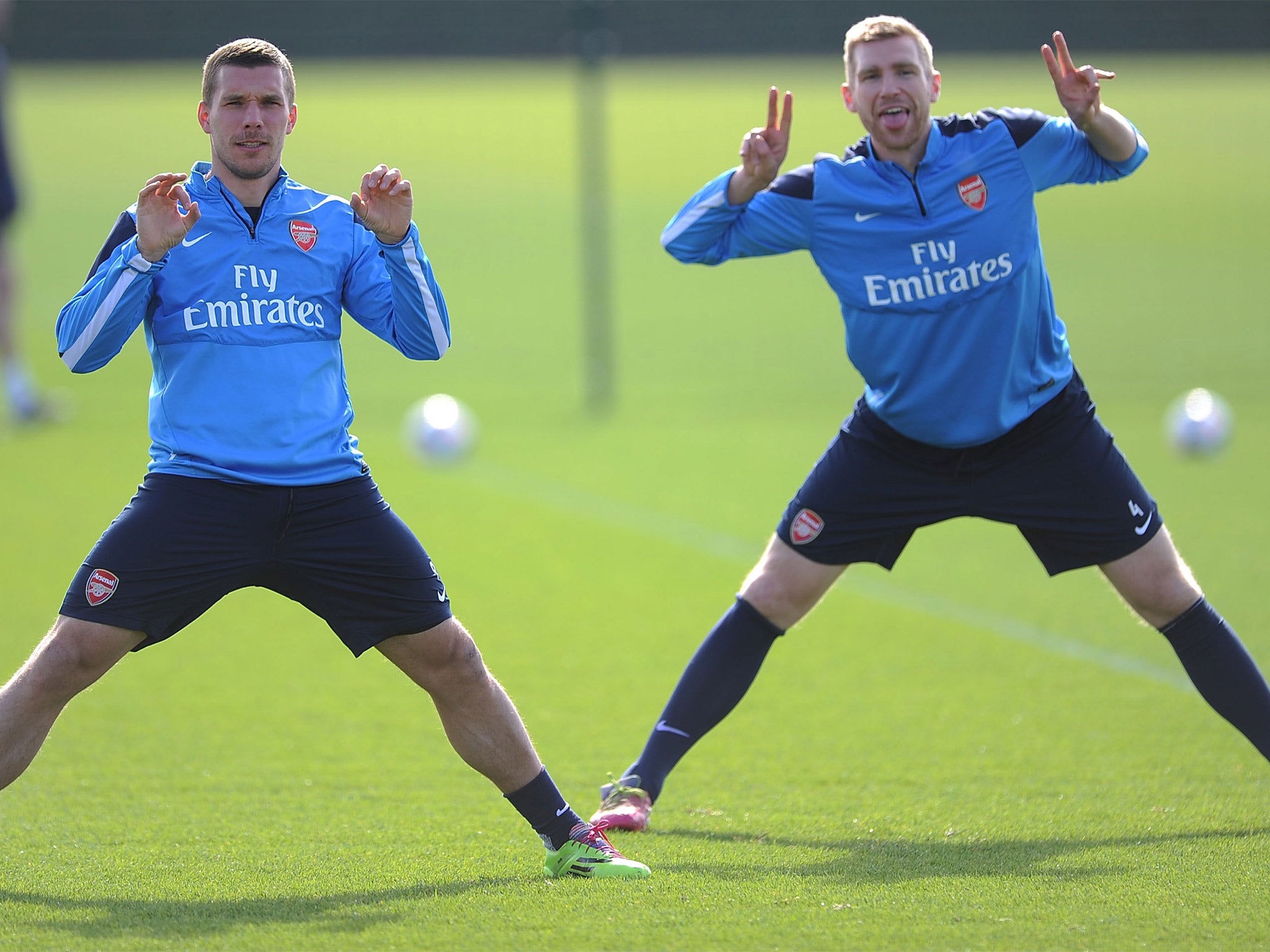 Lukas Podolski (left) with Per Mertesacker. Podolski will only leave Arsenal on a permanent deal, says his manager Arsène Wenger (Getty)