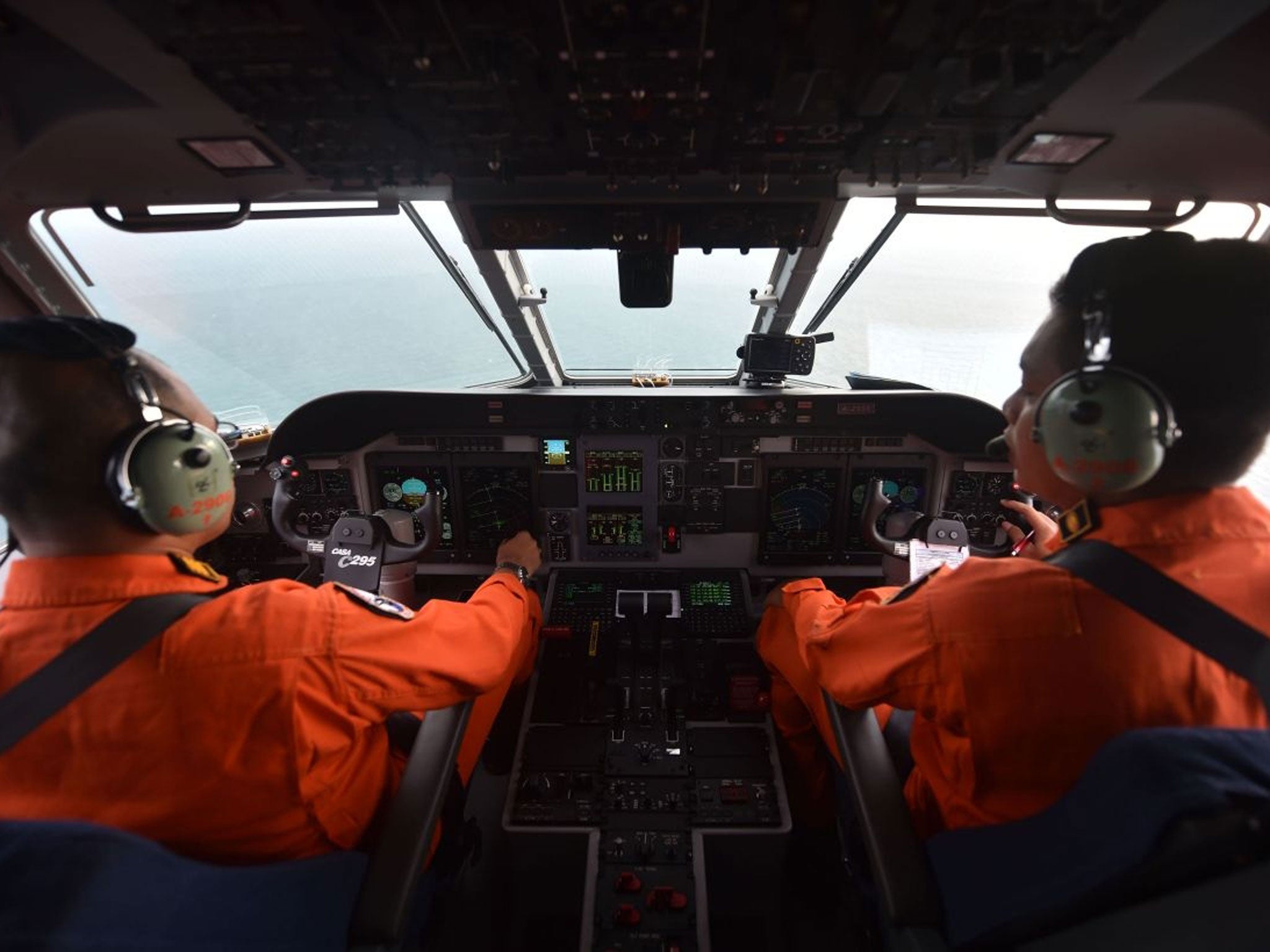 Pilot and co-pilot of the Indonesian air force keep a look out