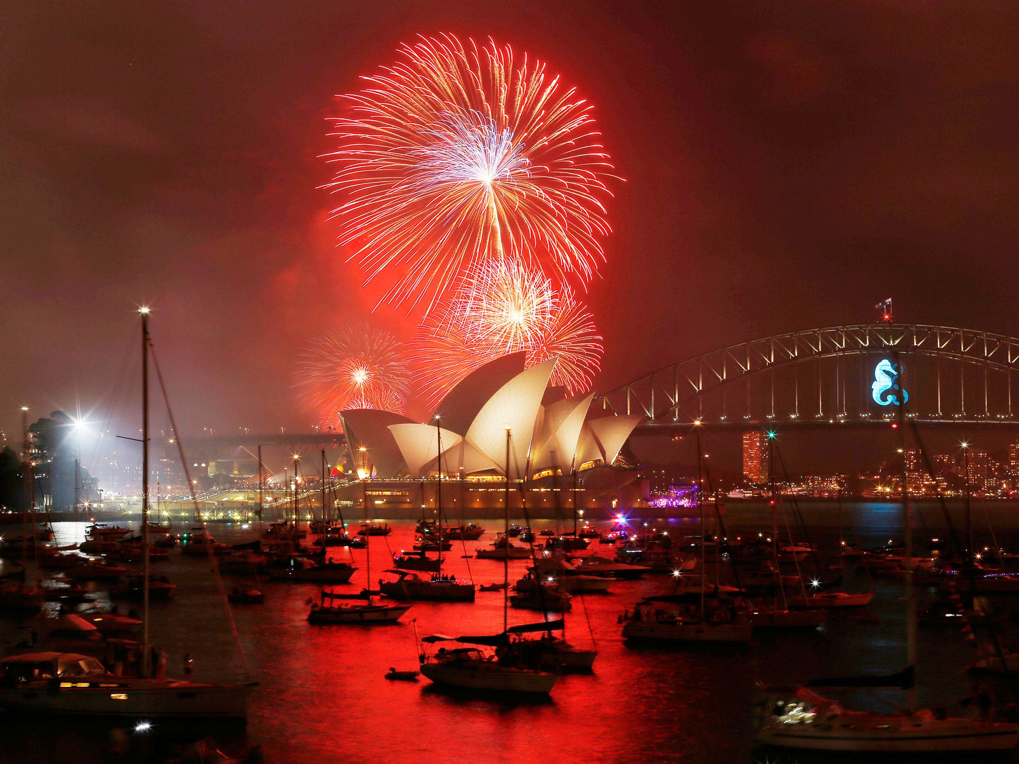 Fireworks light up the Sydney Opera House during an early light show before the midnight New Year fireworks