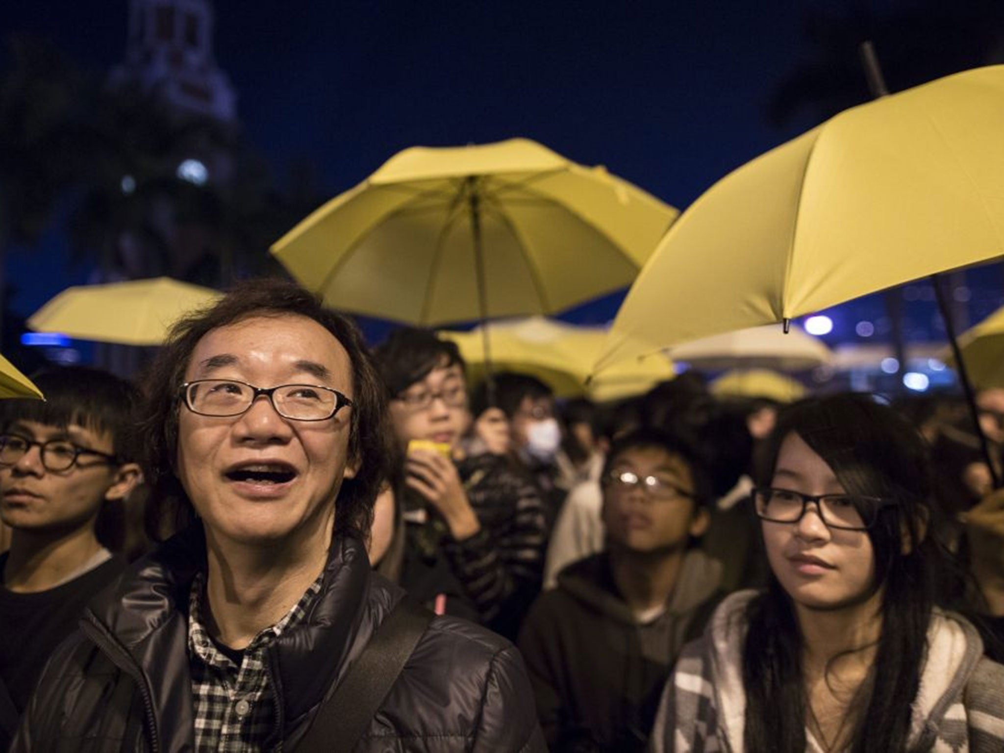 Indonesians hold candles during a vigil for the victims of the crashed AirAsia airplane in Surabaya, East Java, Indonesia.