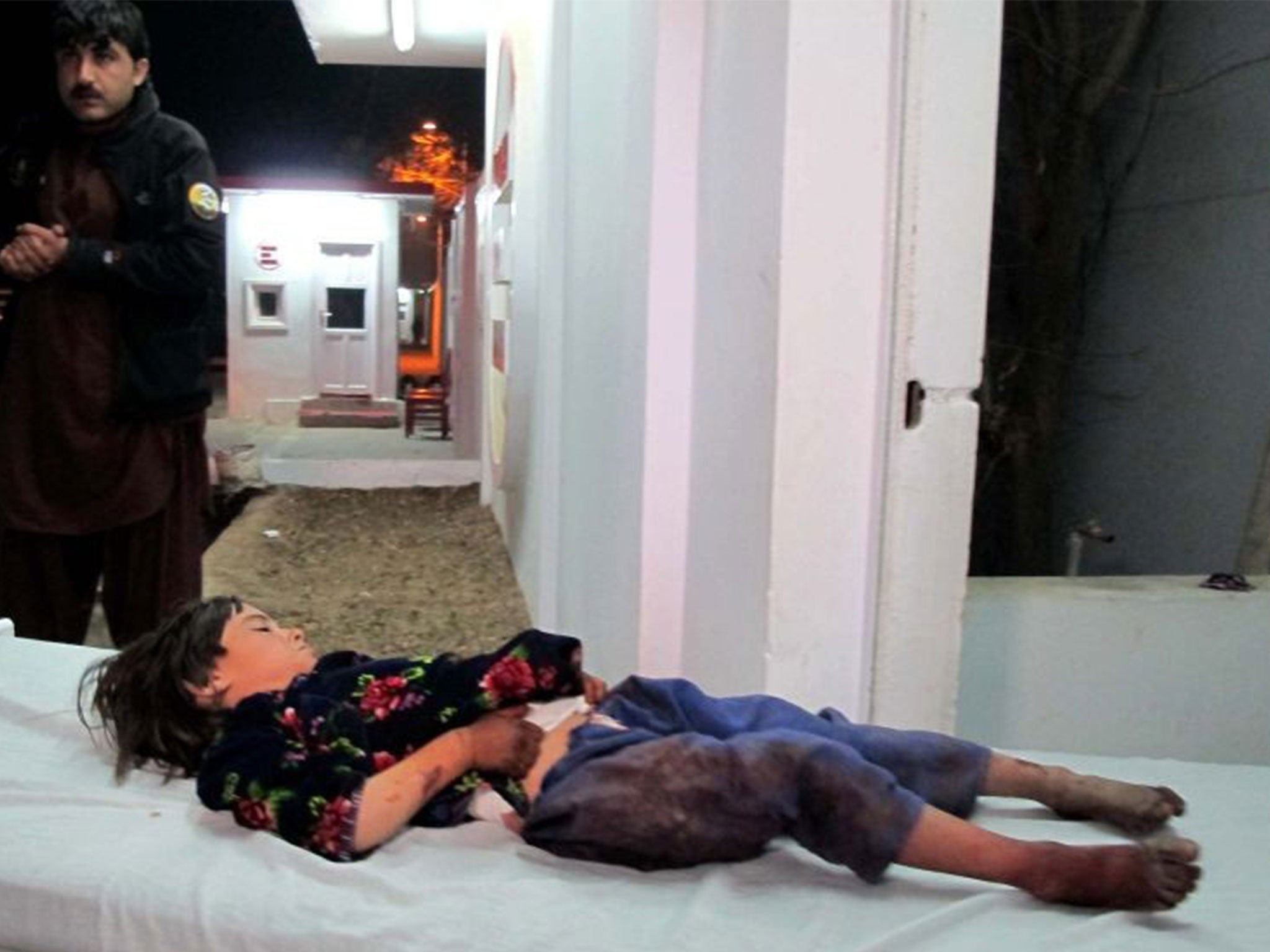 A girl injured in the explosion is rushed to hospital in Lashkar Gah