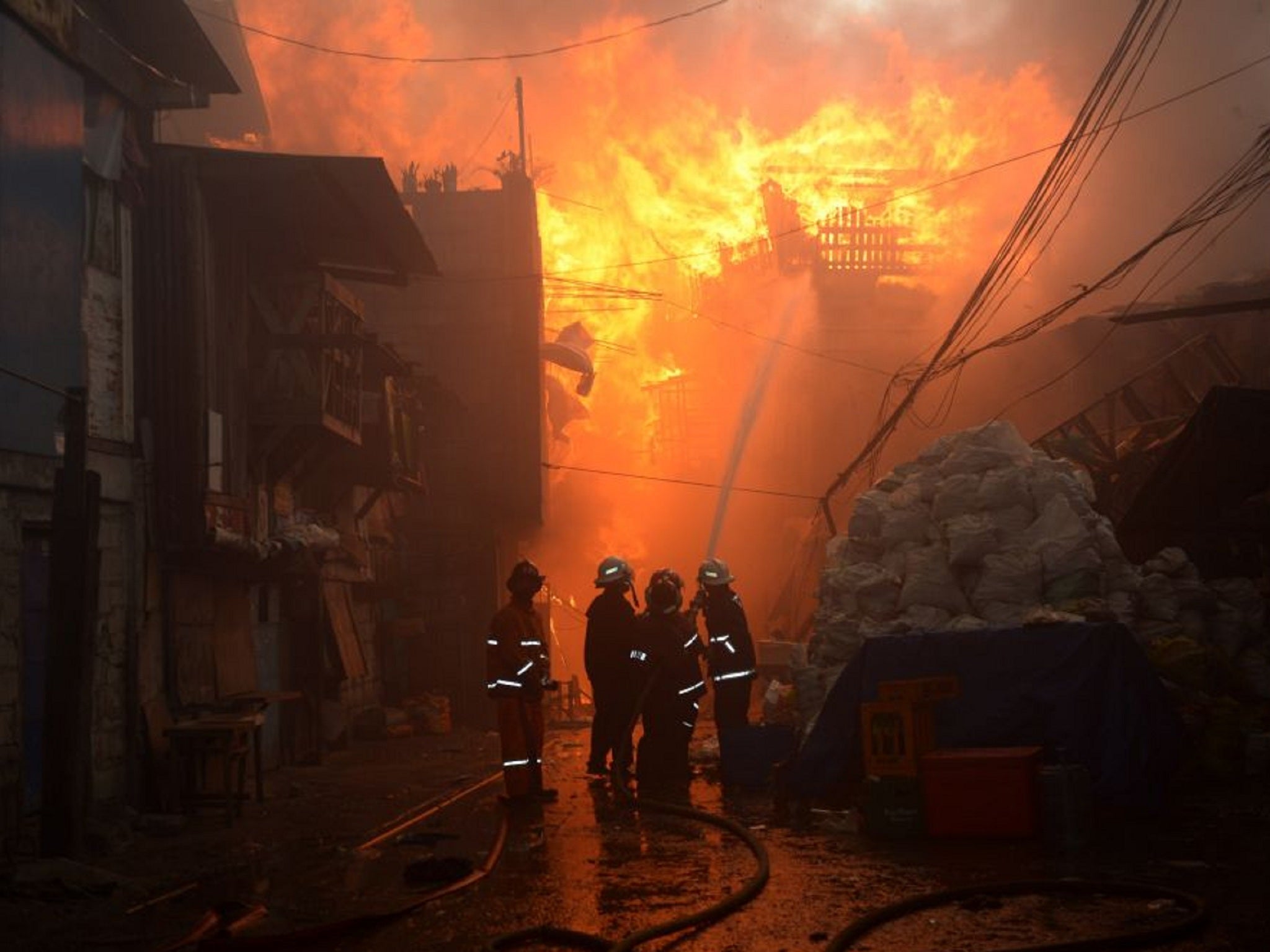 Firefighters attempting to put out the fire on New Year's Eve 2014