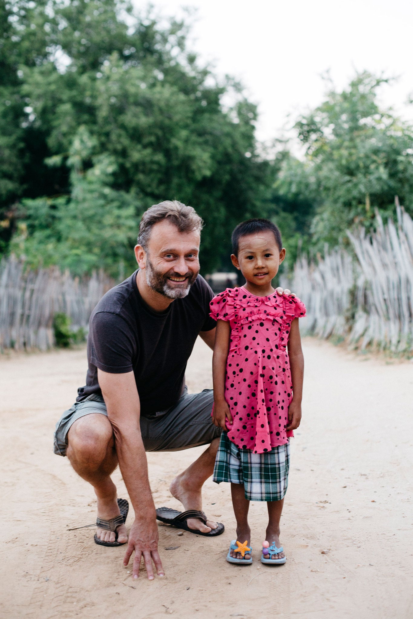 Hugh Dennis with the five-year-old child he sponsors in Myanmar through Actionaid