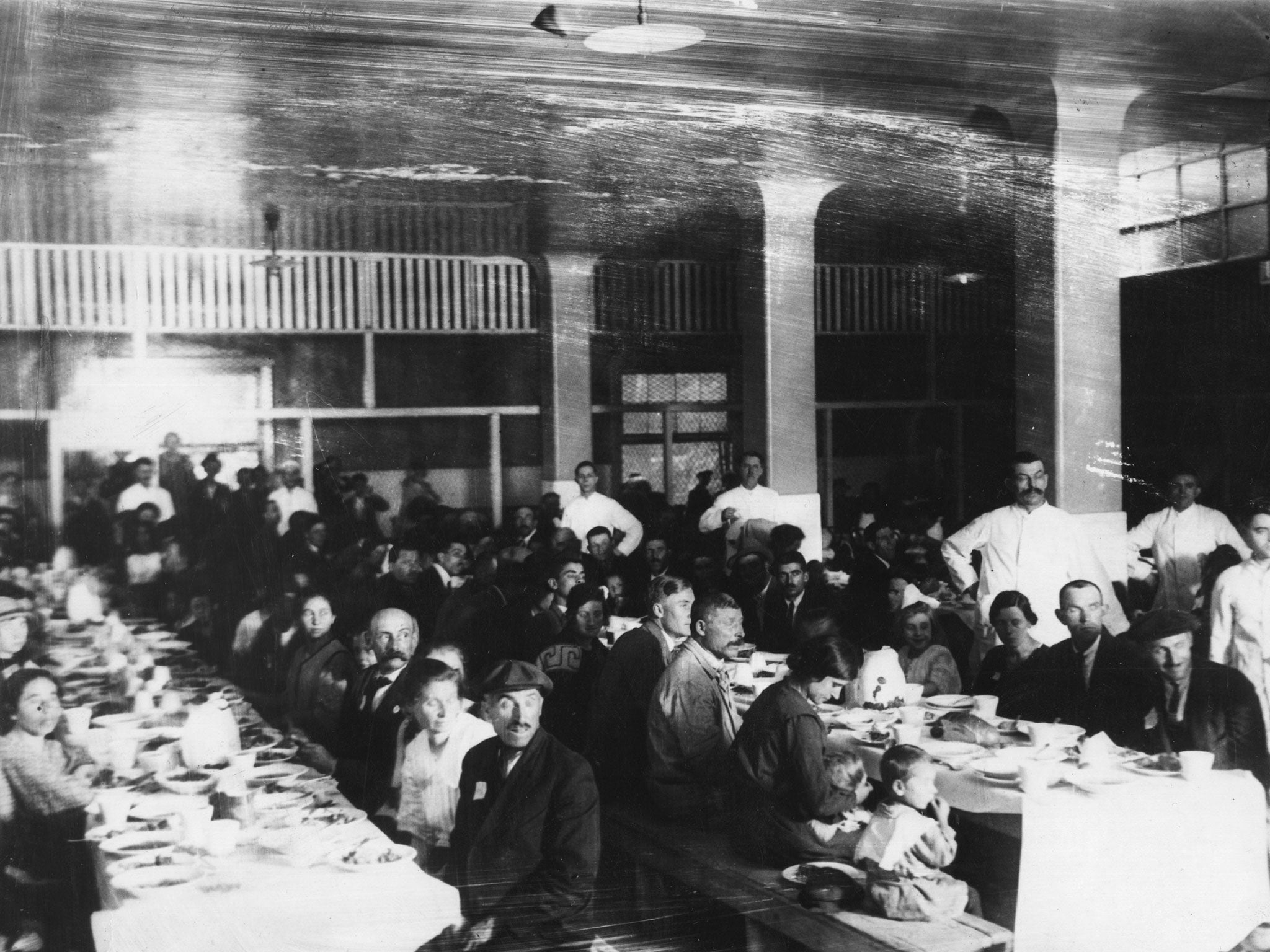 August 1923: Immigrants in a dining hall on Ellis Island, New York.