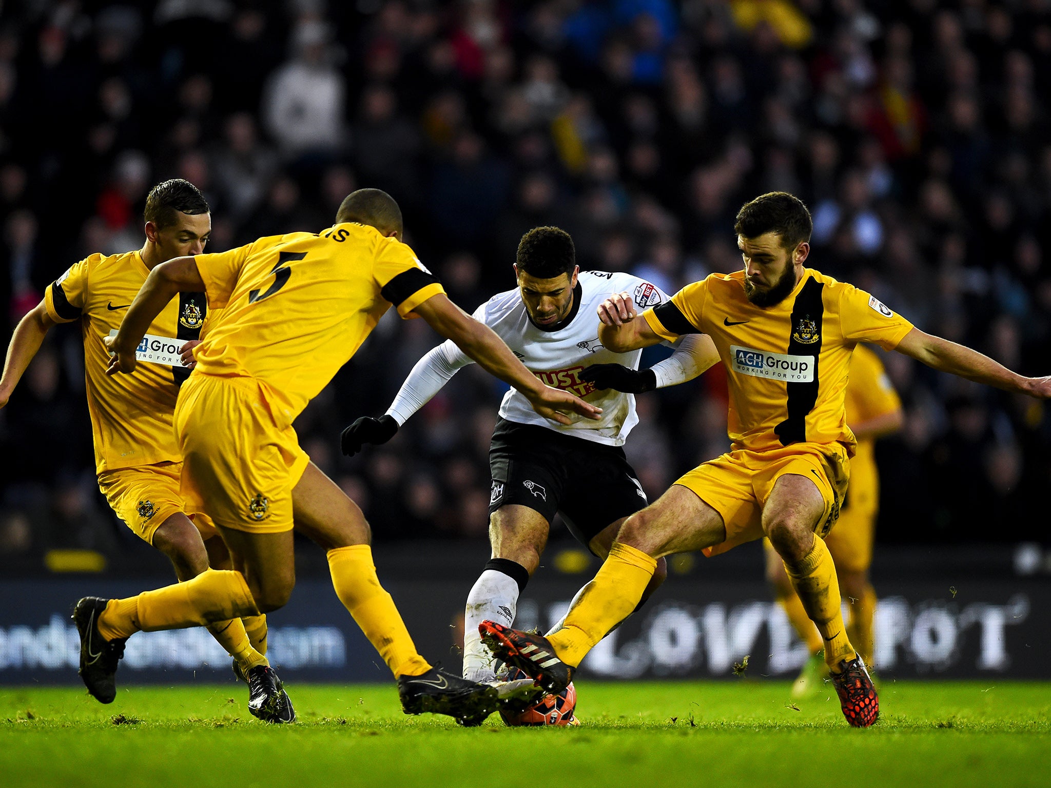 Derby striker Leon Best is crowded out by three defenders