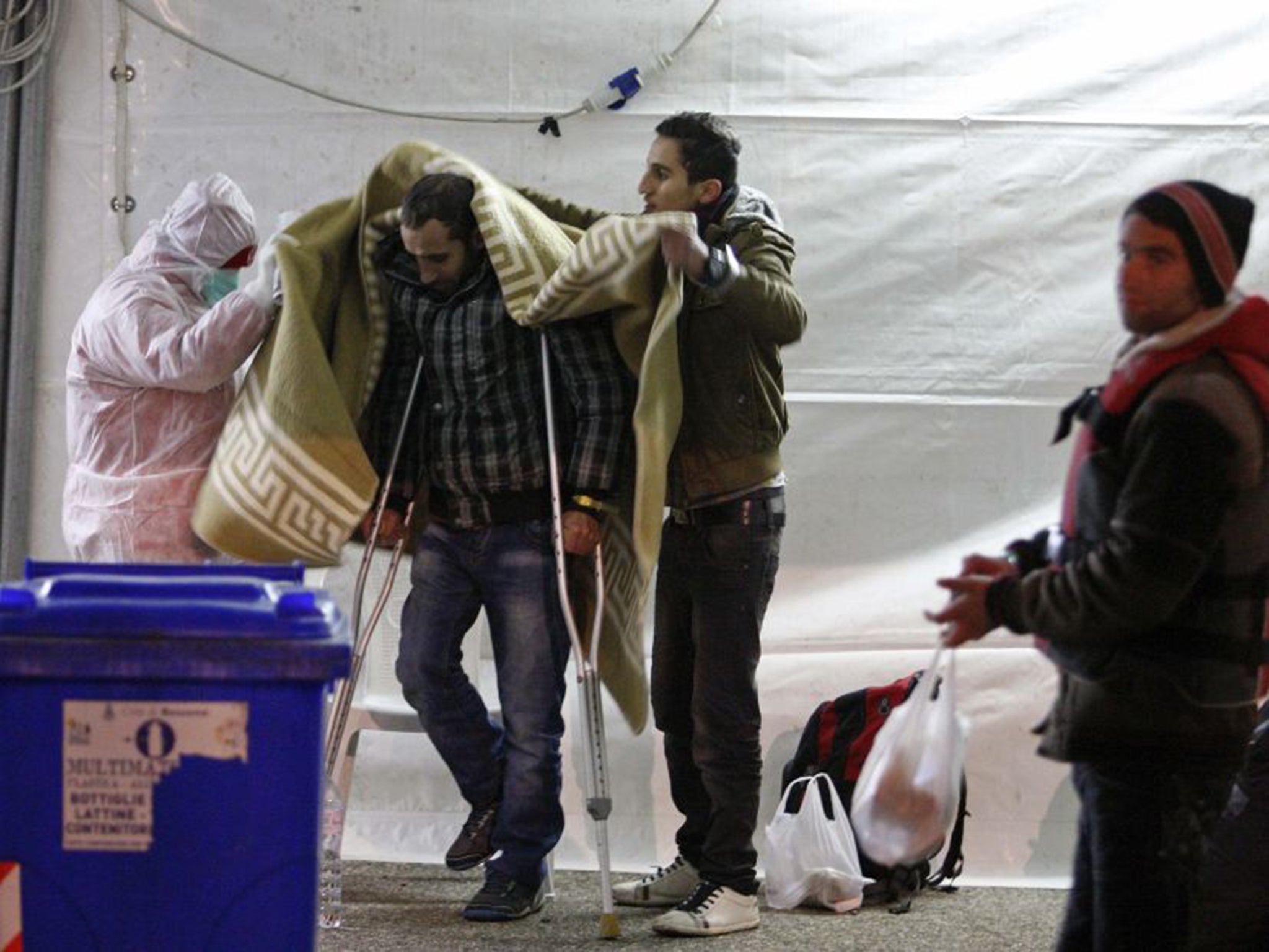 A migrant disembarking from the Sierra Leone-flagged vessel Ezadeen at Corigliano Calabro, Italy, on Saturday (Reuters)