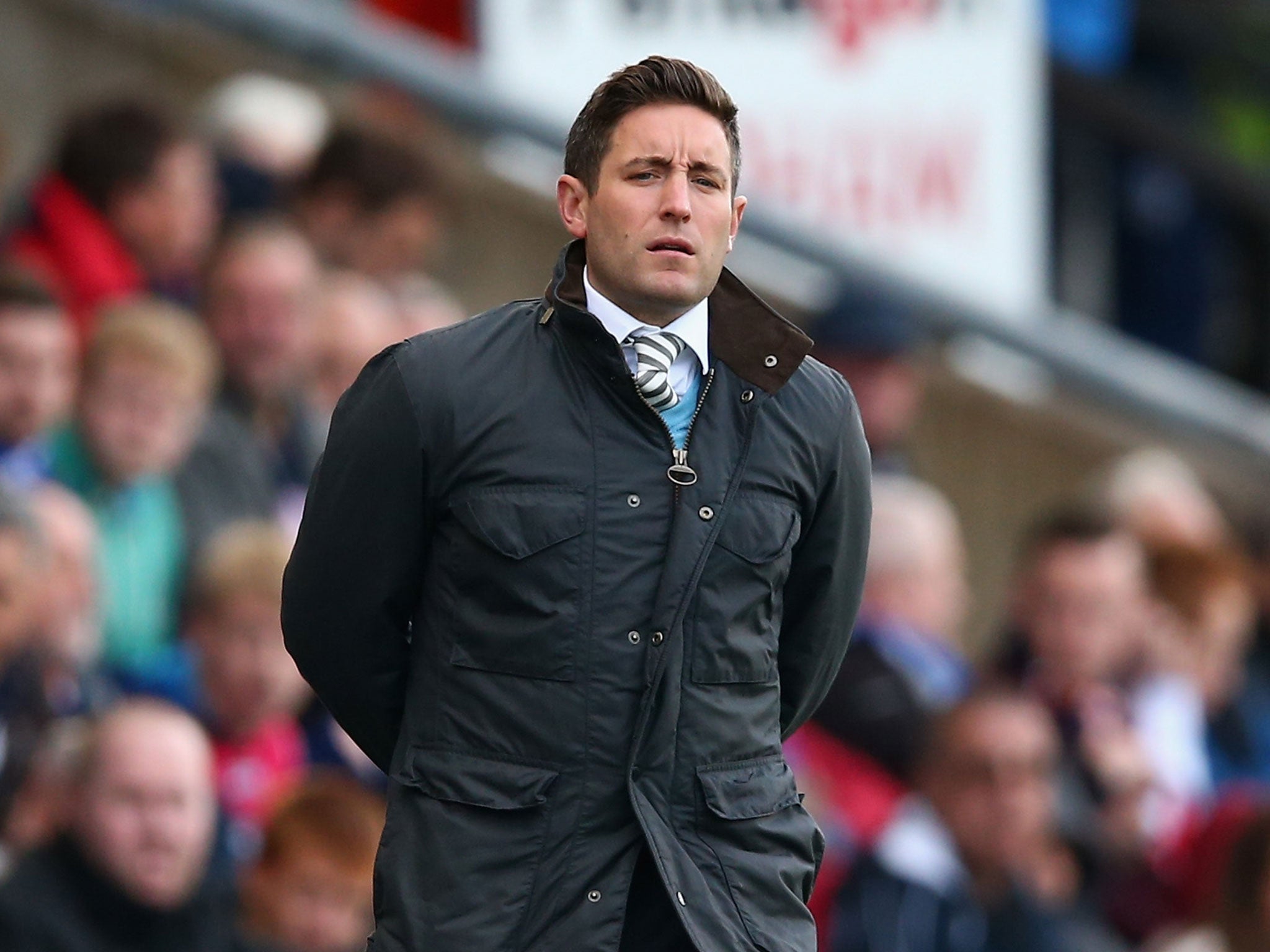 Oldham manager Lee Johnson looks on from the touchline